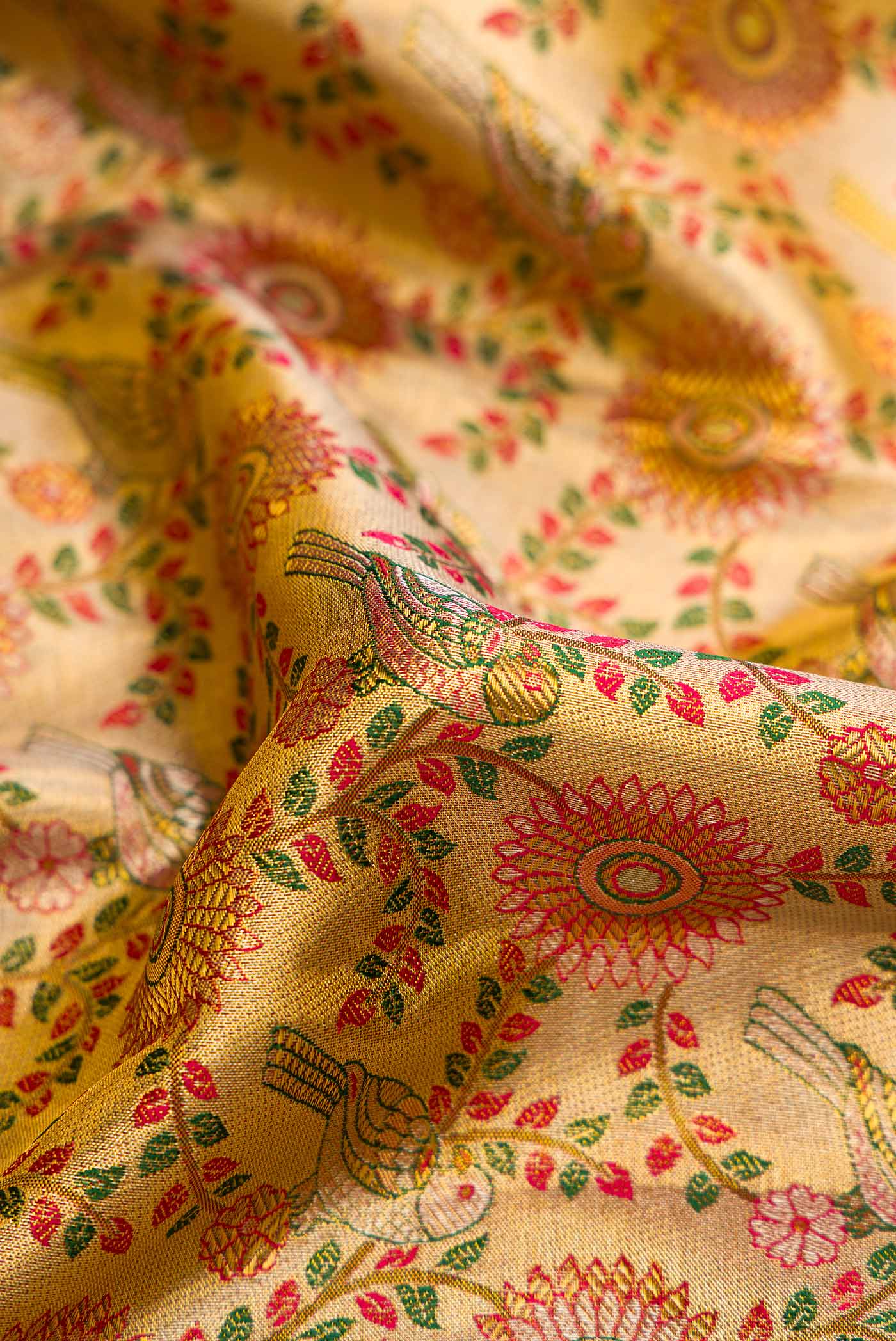 Close up of Gold Dual Tone Kanchipuram Tissue Silk Saree with Zari Brocade on the body and Zari Border.  displaying folds