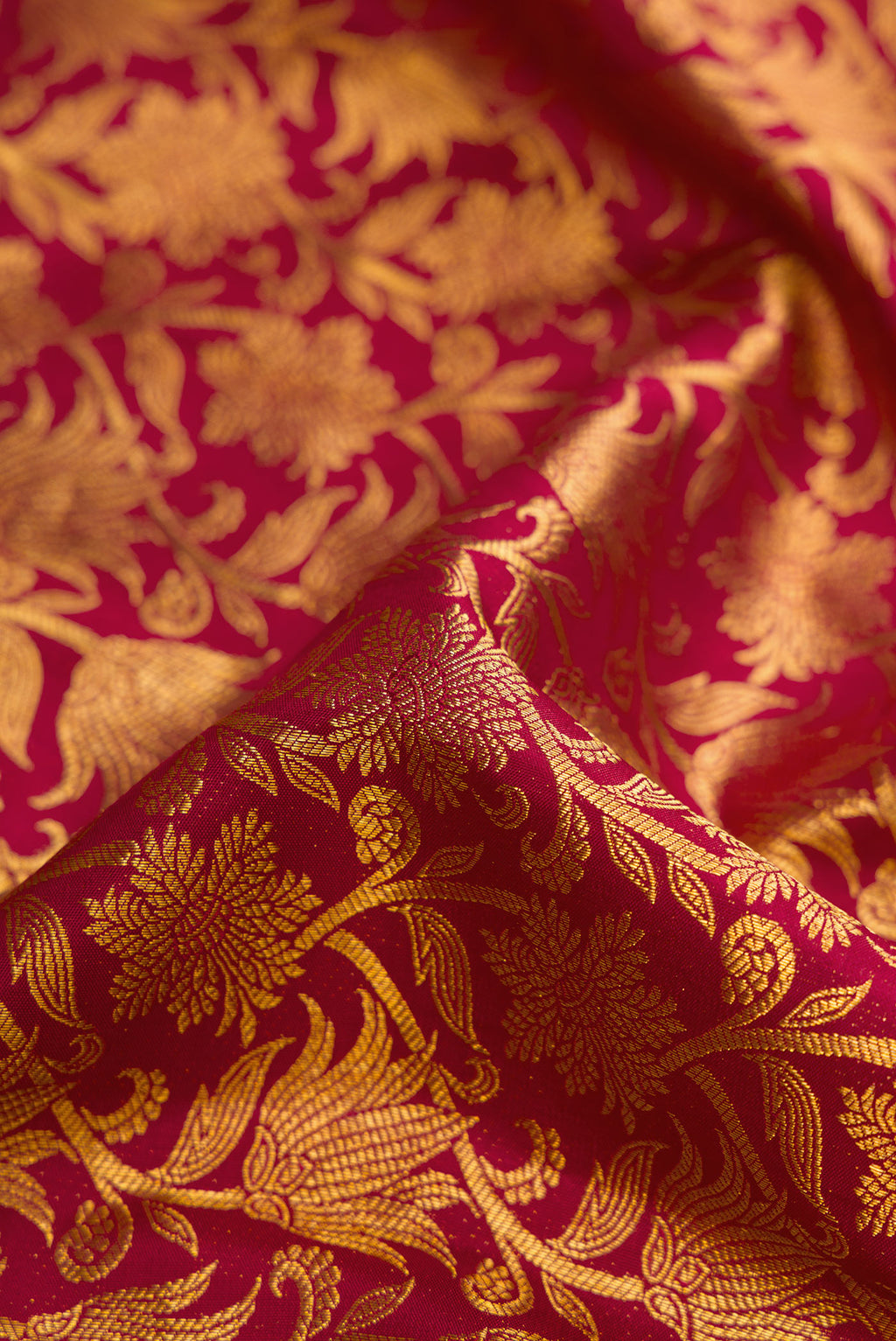 Close up of Maroon Dual Tone Kanchipuram Silk Saree with Zari Brocade on the body and Zari Border.  displaying folds
