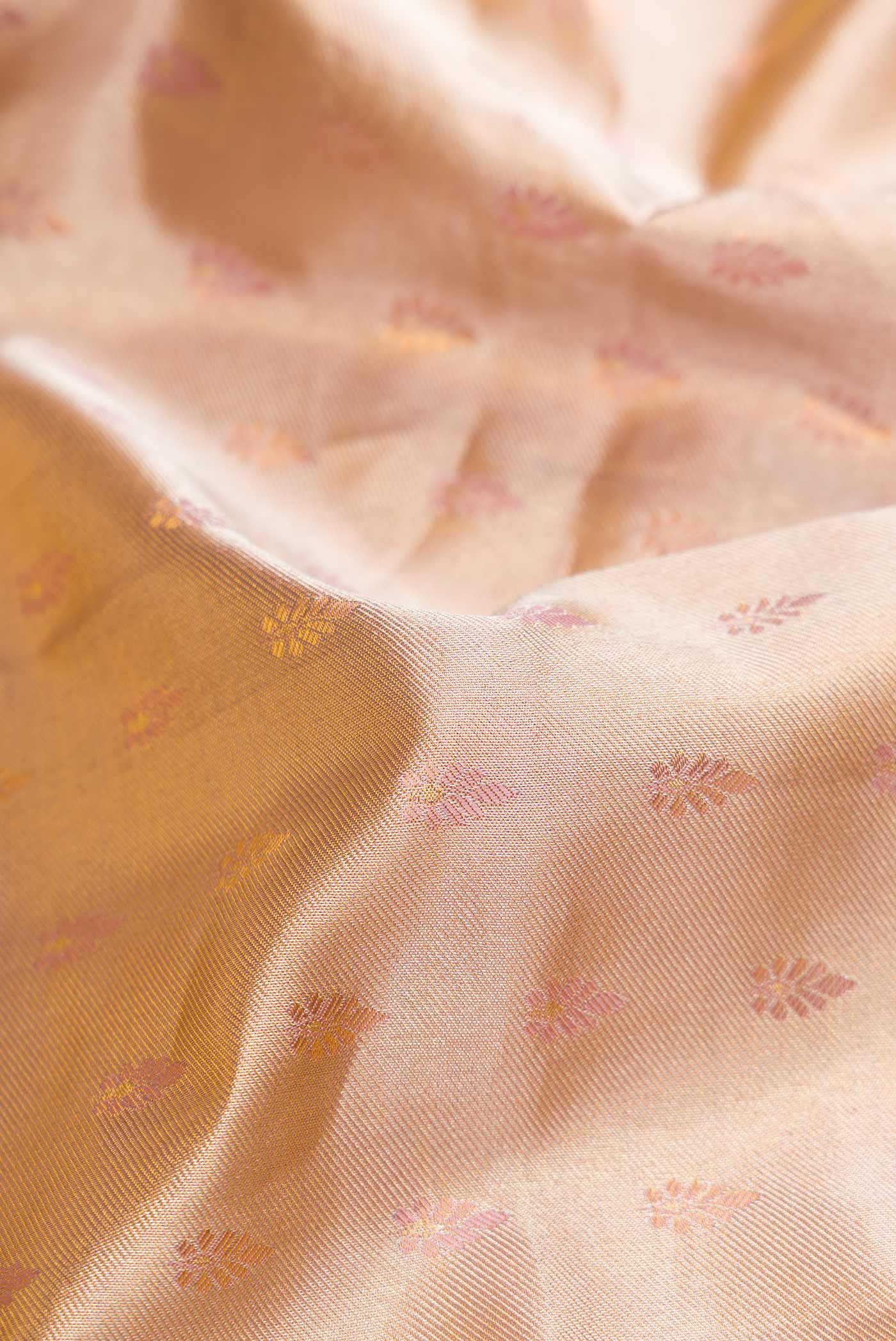 Close up of Gold Dual Tone Kanjivaram Tissue Silk Saree with Zari Brocade on the body and Zari Border.  displaying folds