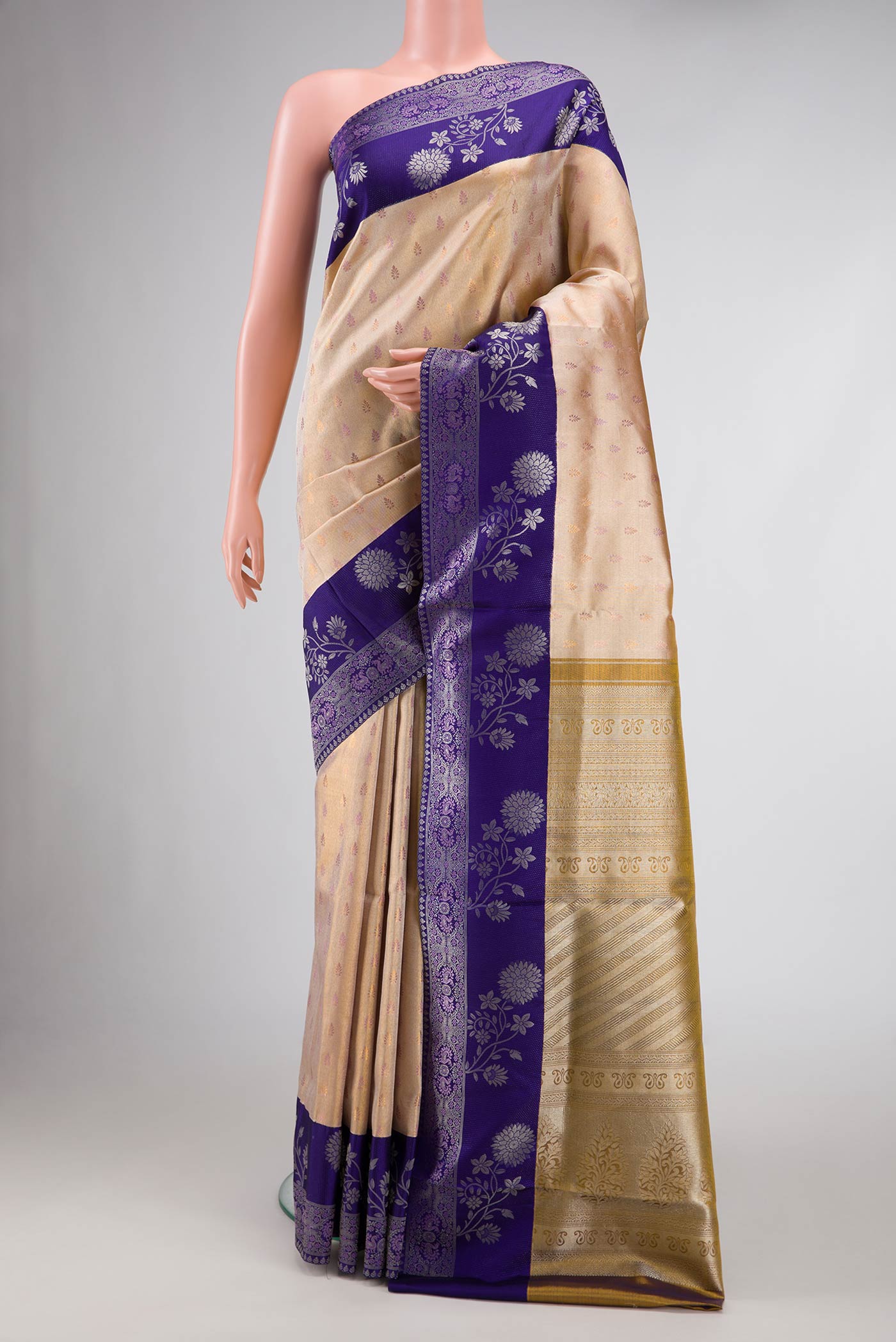 Gold Dual Tone Kanjivaram Tissue Silk Saree with Zari Brocade on the body and Zari Border.  displayed on a mannequin