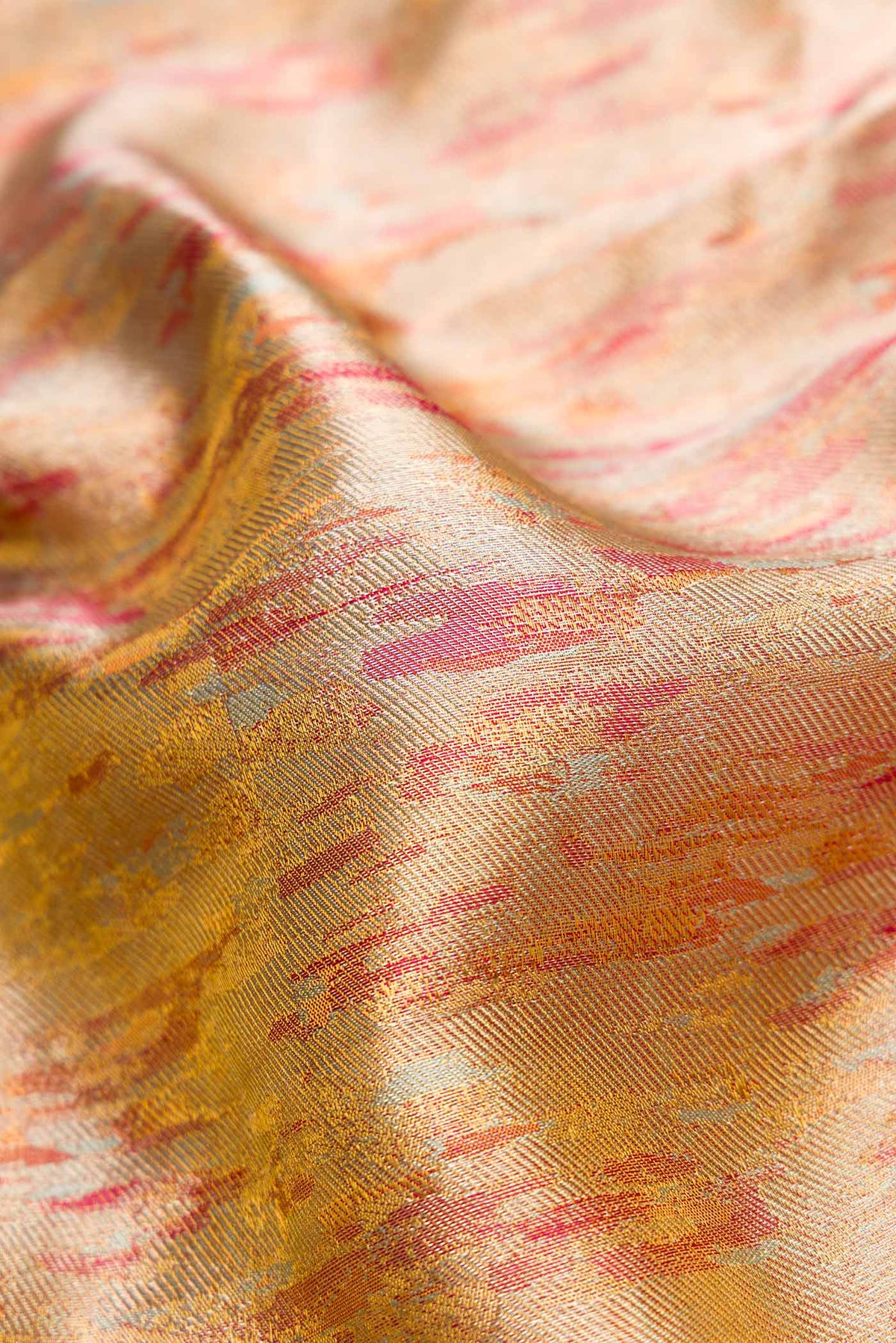 Close up of Gold Dual Tone Kanjivaram Tissue Silk Saree with Zari Brocade on the body and Zari Border.  displaying folds
