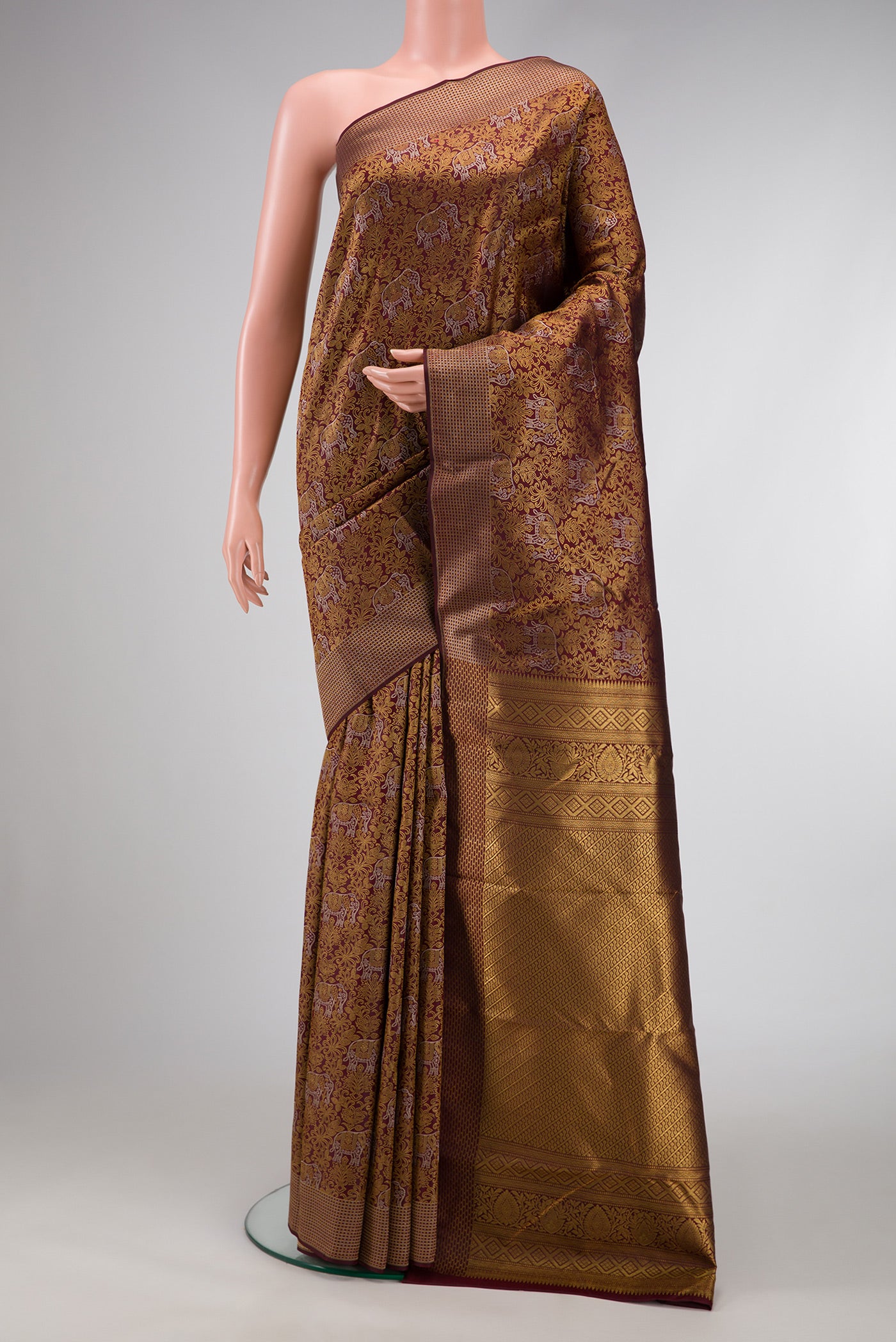 Maroon Dual Tone Kanchipuram Silk Saree with Zari Brocade on the body and Zari Border.  displayed on a mannequin
