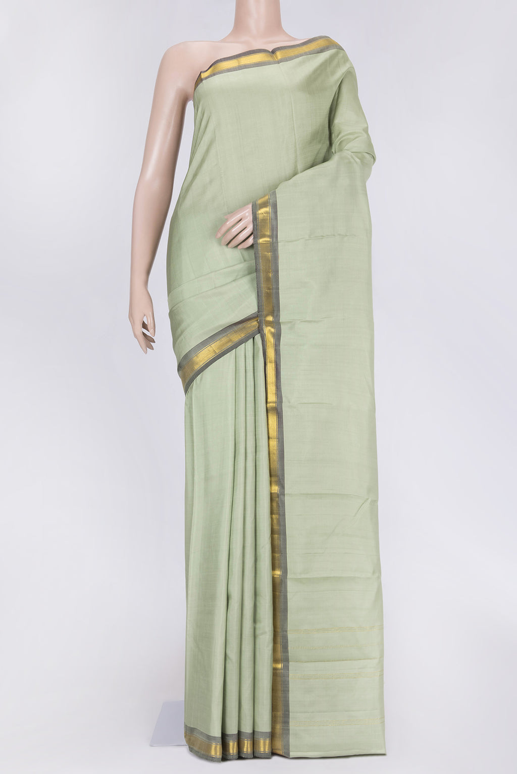 Pista Green Dual Tone Kanchipuram Saree with Plain Body and Zari Border.  displayed on a mannequin