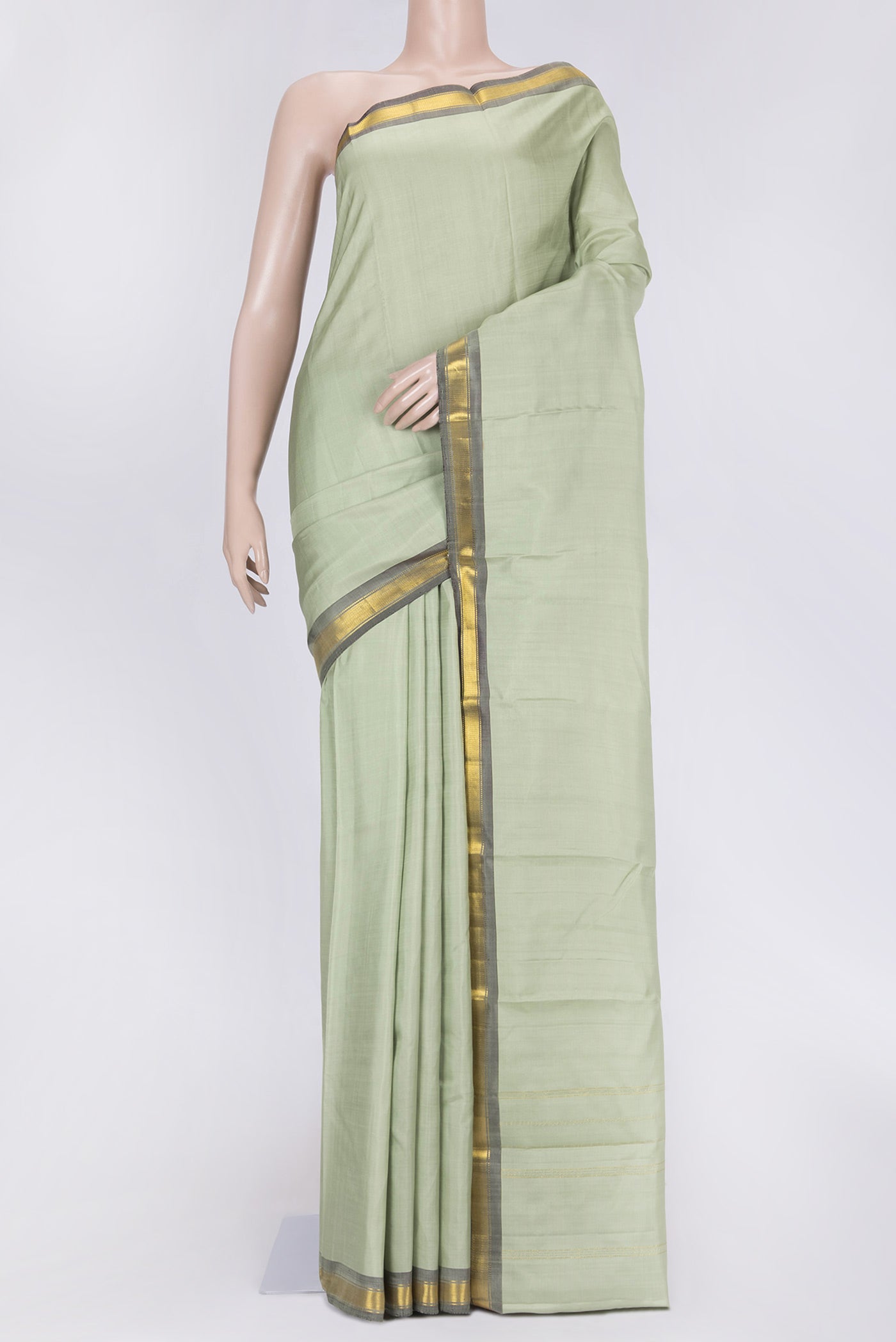 Pista Green Dual Tone Kanchipuram Saree with Plain Body and Zari Border.  displayed on a mannequin