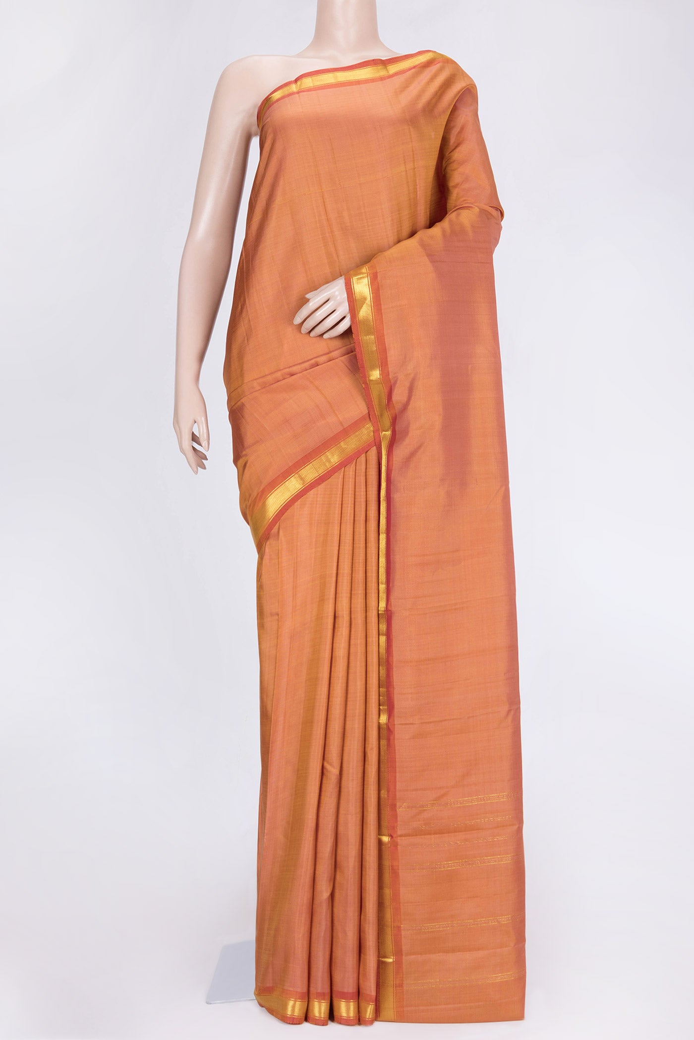 Golden Peach Dual Tone Kanchipuram Saree with Plain Body and Zari Border.  displayed on a mannequin