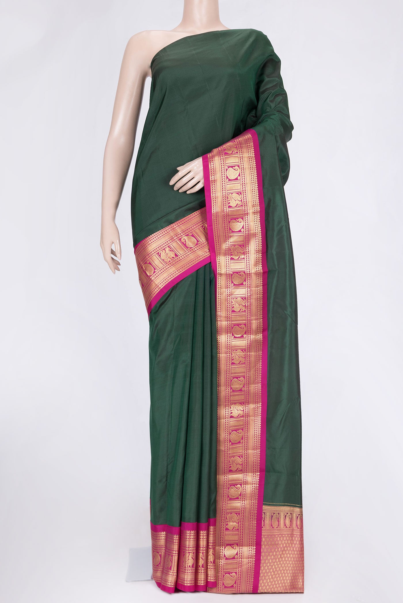 Bottle Green Dual Tone Kanchipuram Saree with Plain Body and Zari Border.  displayed on a mannequin