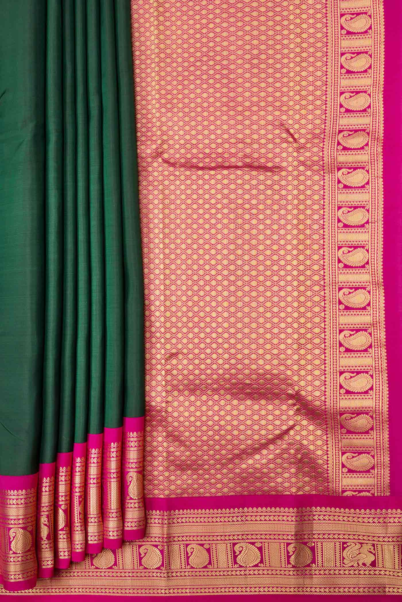 Pleats and pallu of Bottle Green Dual Tone Kanchipuram Saree with Plain Body and Zari Border. 