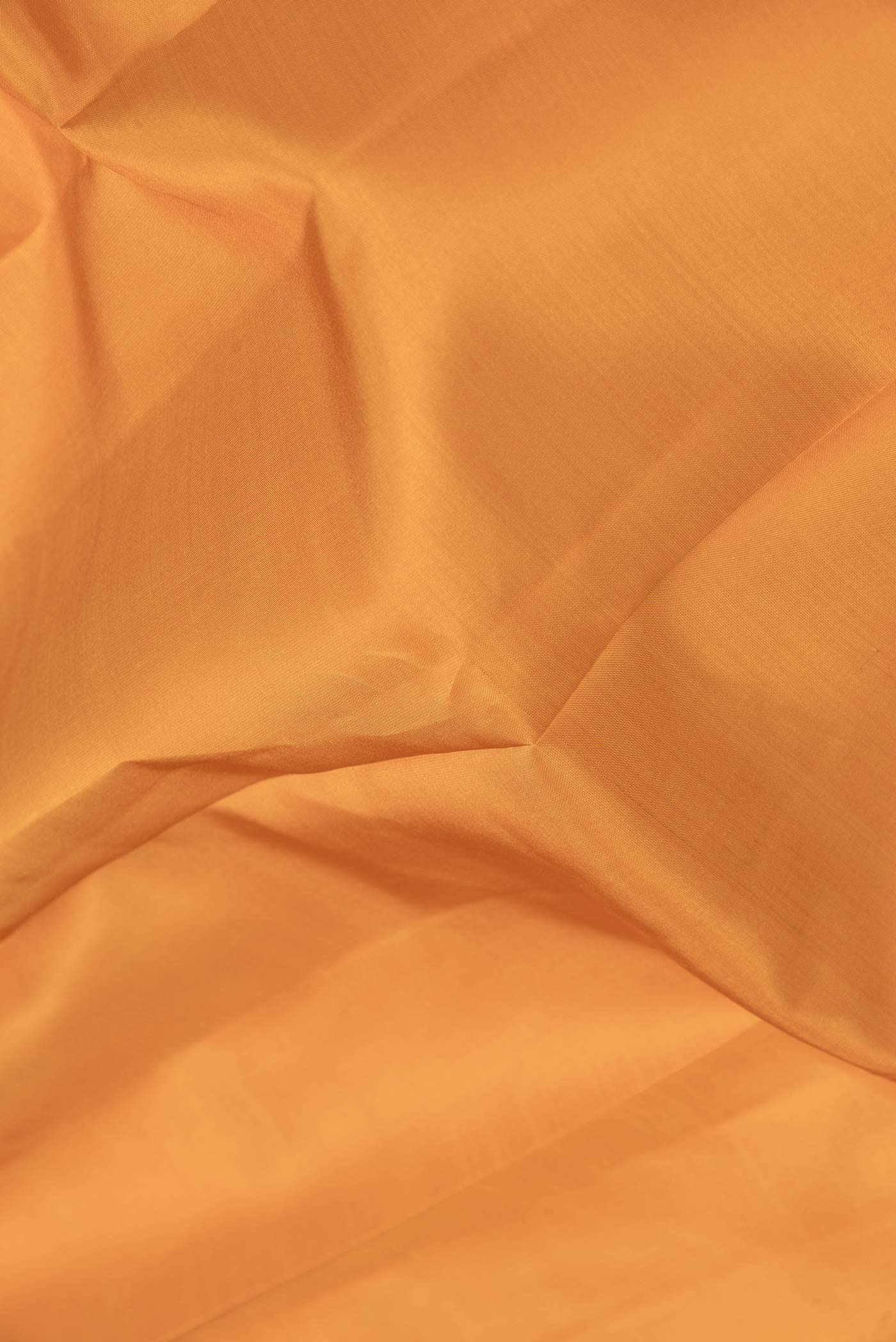 Close up of Mustard Dual Tone Kanchipuram Saree with Plain Body and Zari Border.  displaying folds