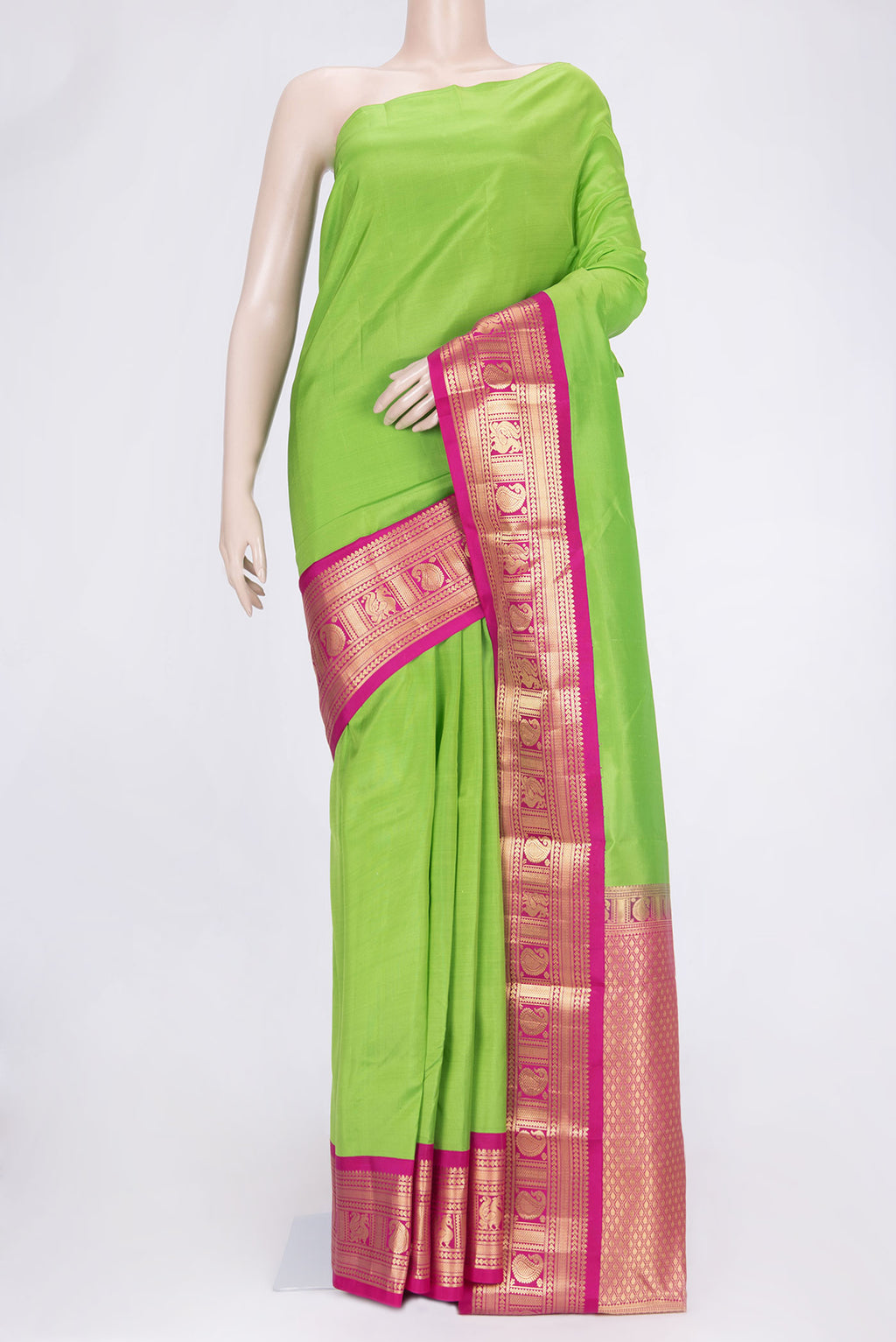 Parrot Green Dual Tone Kanchipuram Saree with Plain Body and Zari Border.  displayed on a mannequin