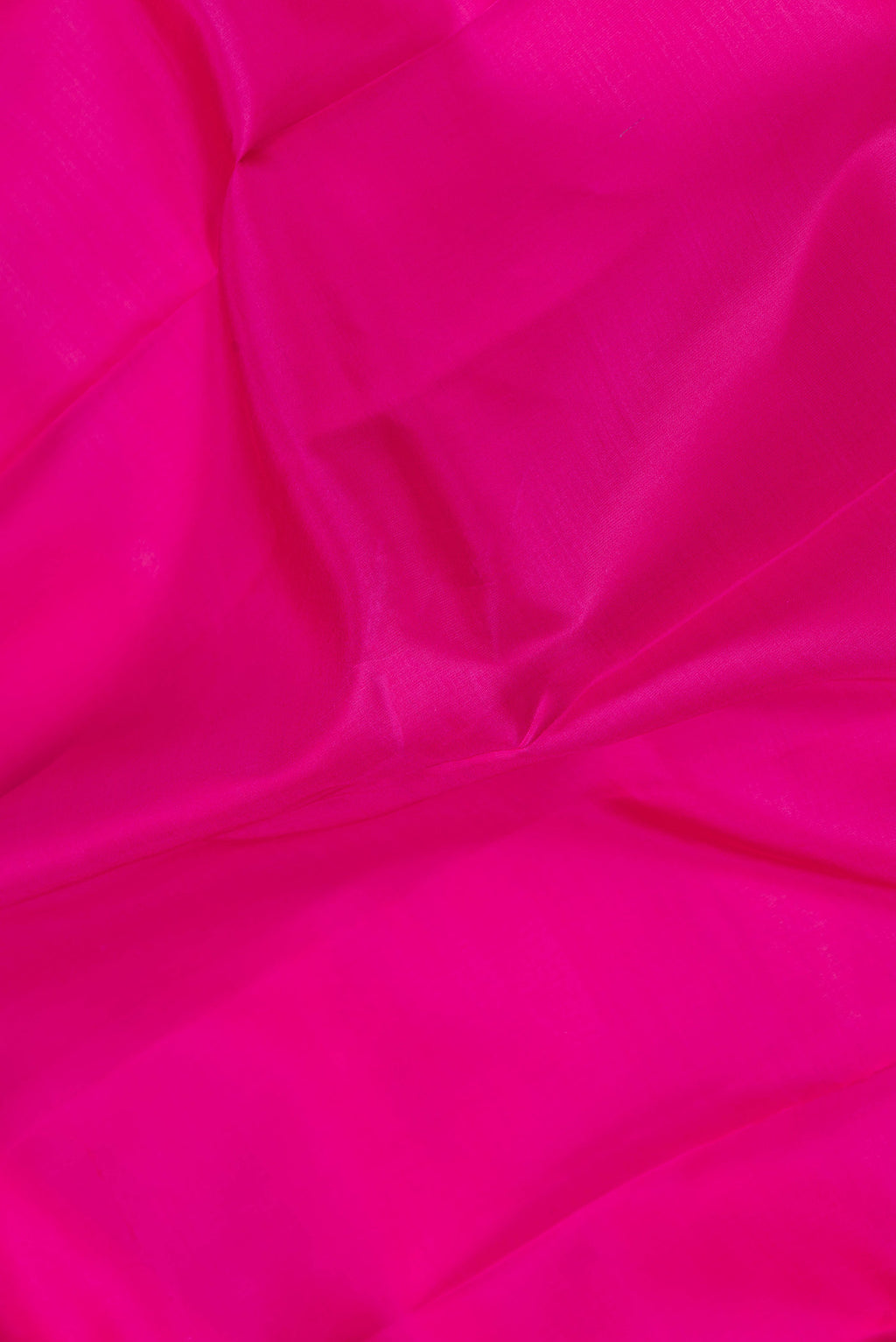 Close up of Pink Dual Tone Kanchipuram Saree with Plain Body and Zari Border.  displaying folds