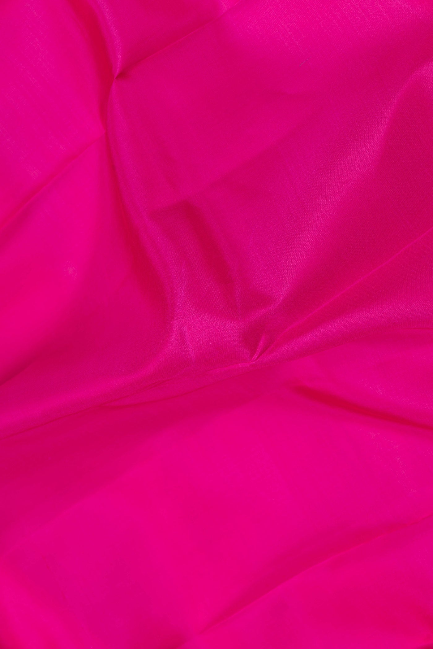 Close up of Pink Dual Tone Kanchipuram Saree with Plain Body and Zari Border.  displaying folds