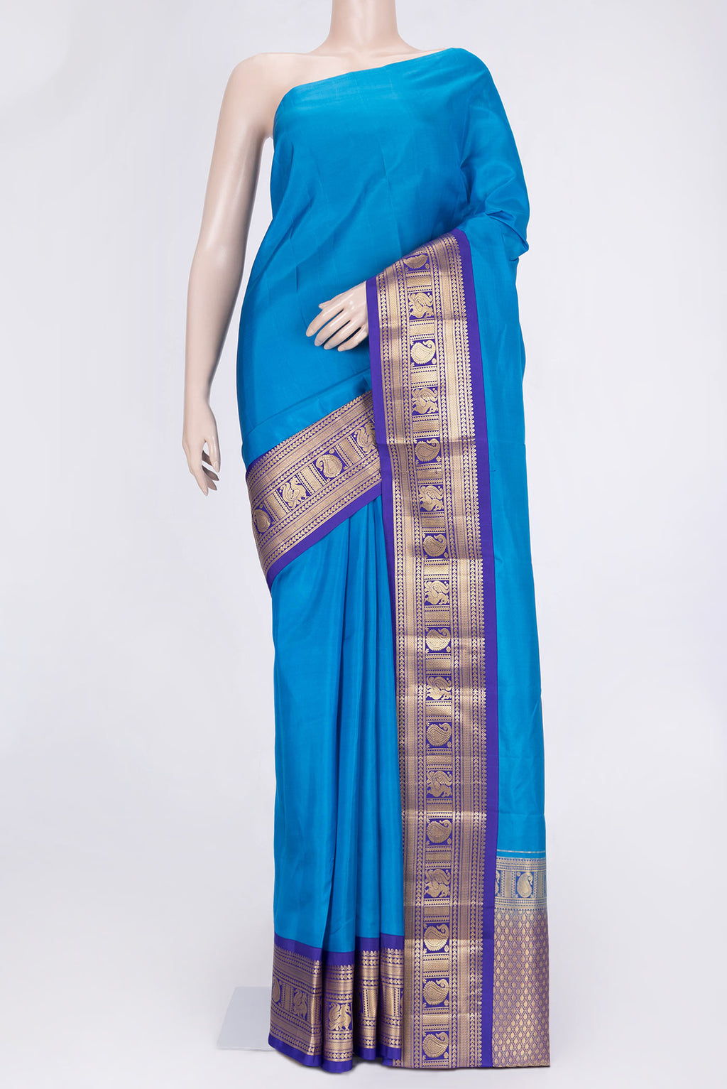 Peacock Blue Dual Tone Kanchipuram Saree with Plain Body and Zari Border.  displayed on a mannequin