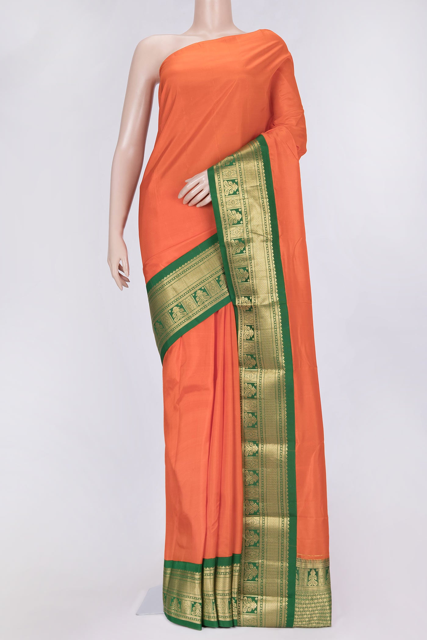 Orange Dual Tone Kanchipuram Saree with Plain Body and Zari Border.  displayed on a mannequin