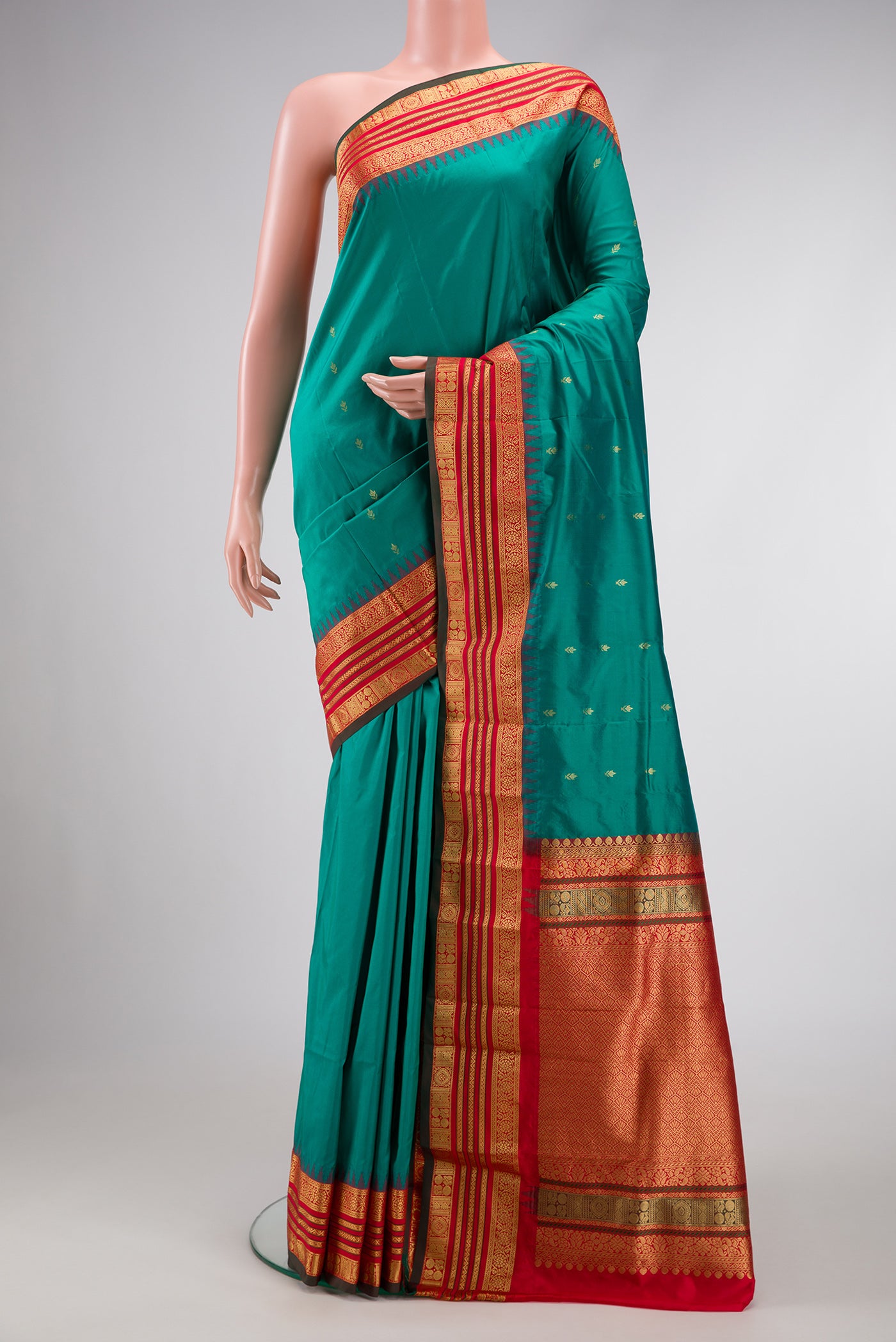 Green Dual Tone Kanchipuram Silk Saree with Zari Butta on the body and Zari Border.  displayed on a mannequin