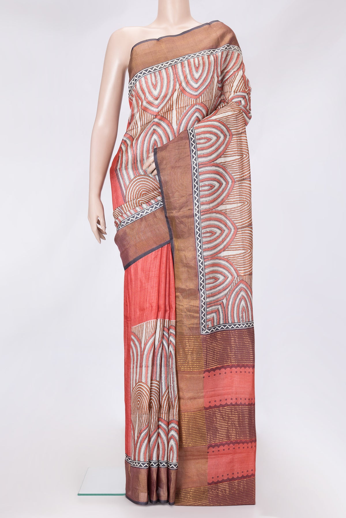 Red Dual Tone Tussar Silk Saree with Printed design on the body and Zari Border.  displayed on a mannequin