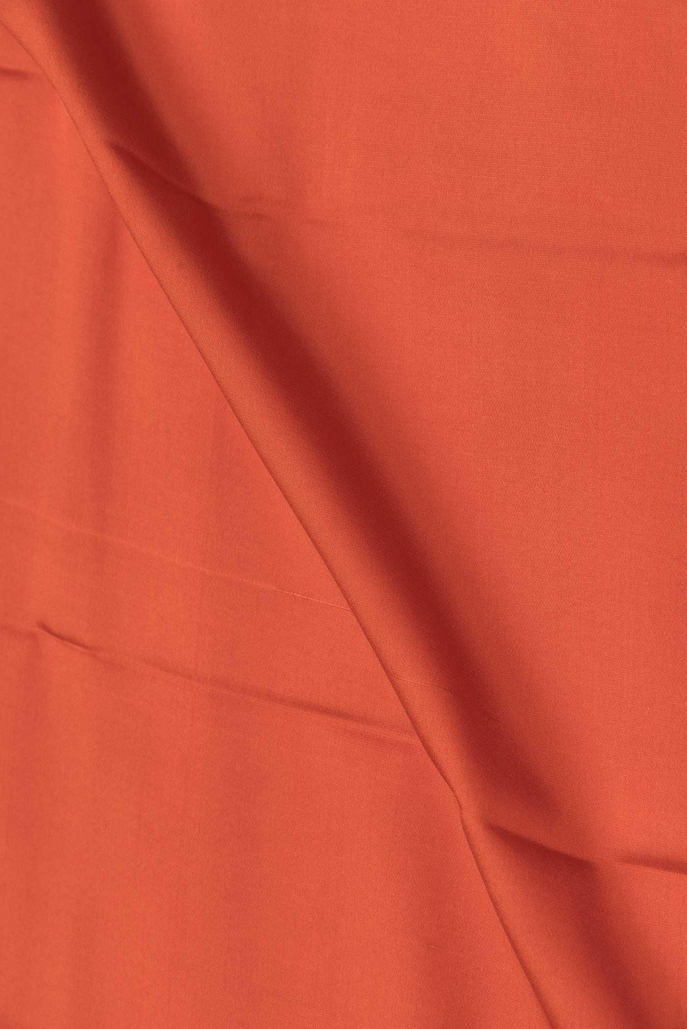 Close up of Orange Mysore Crepe Saree with Plain Body and Zari Border displaying folds