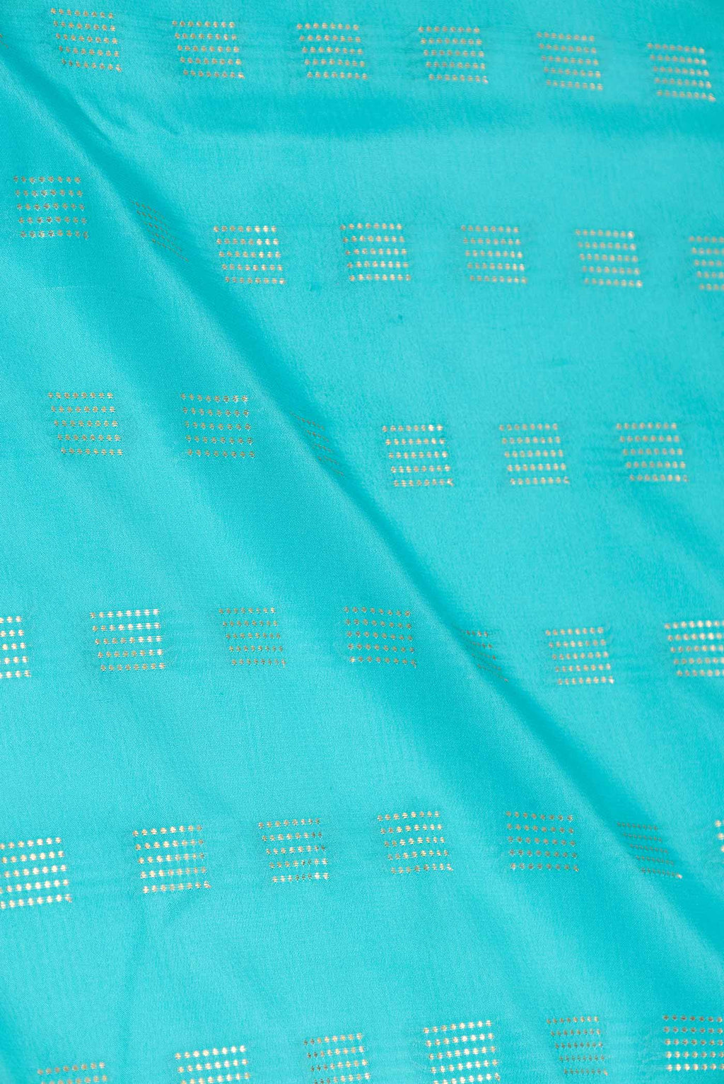 Close up of Sky Blue Dual Tone Mysore Crepe Saree with Zari Butta on the body and Zari Border displaying folds
