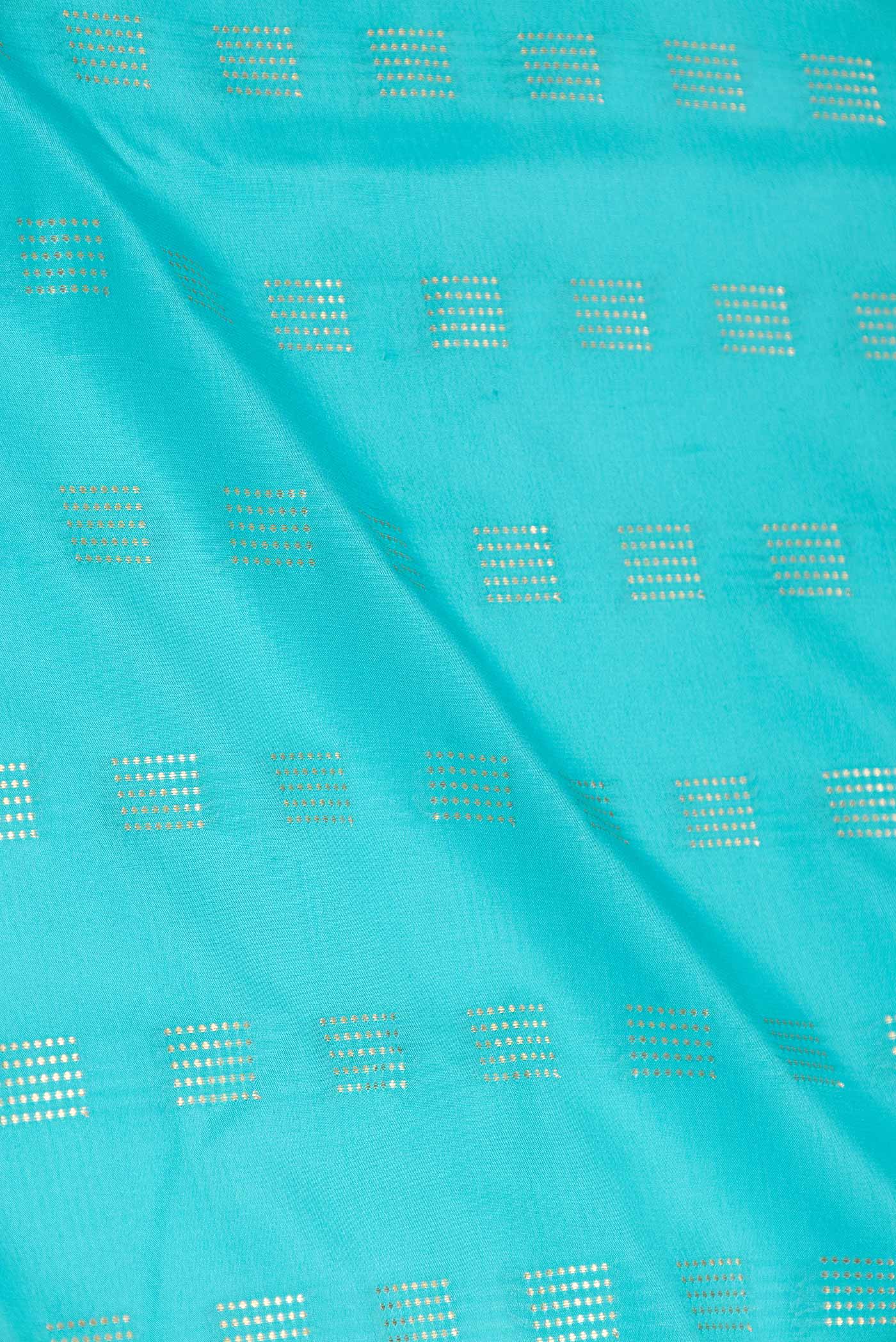 Close up of Sky Blue Dual Tone Mysore Crepe Saree with Zari Butta on the body and Zari Border displaying folds