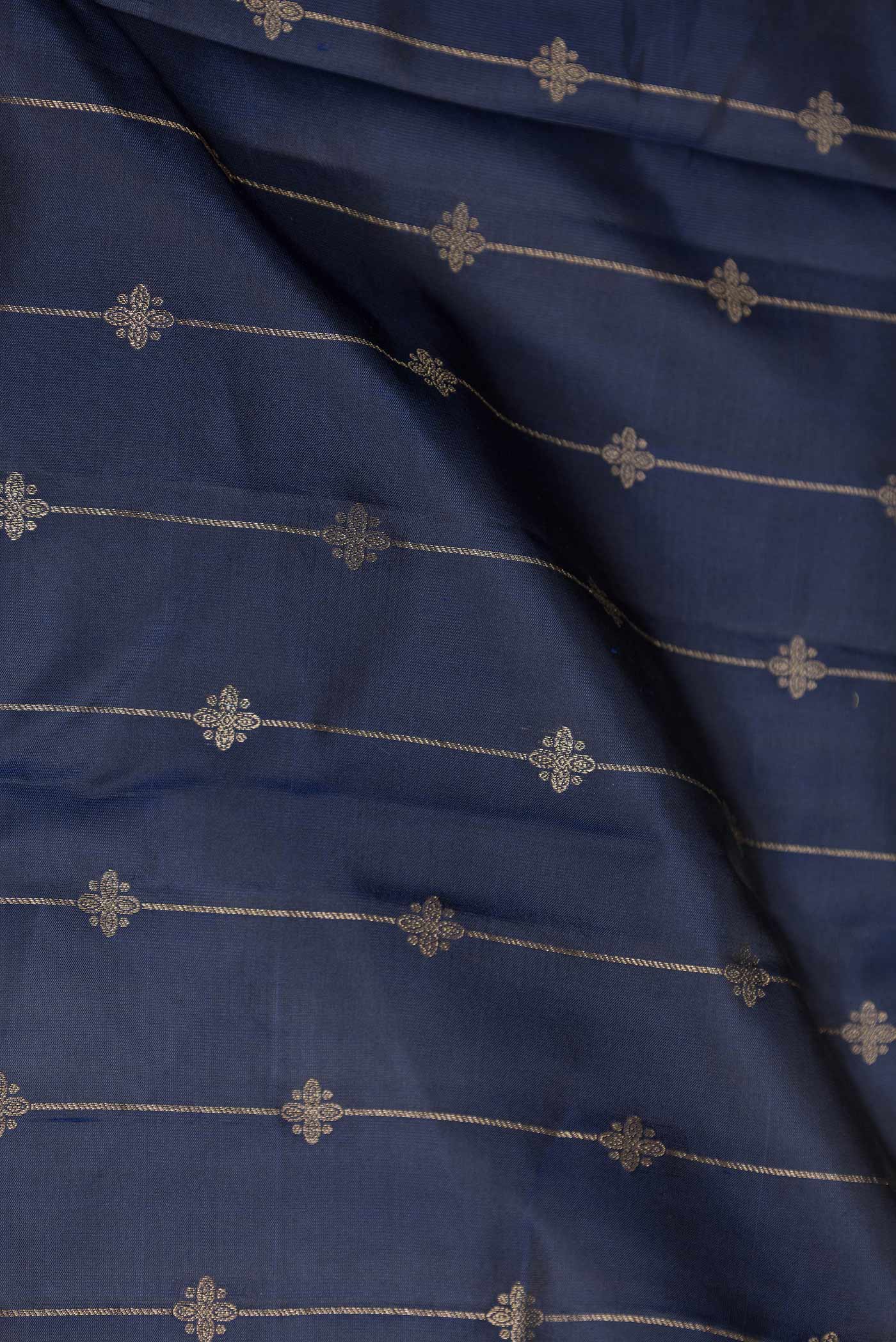 Close up of Navy Blue Dual Tone Kanchipuram Silk Saree with Zari Butta on the body and Fancy Border displaying folds