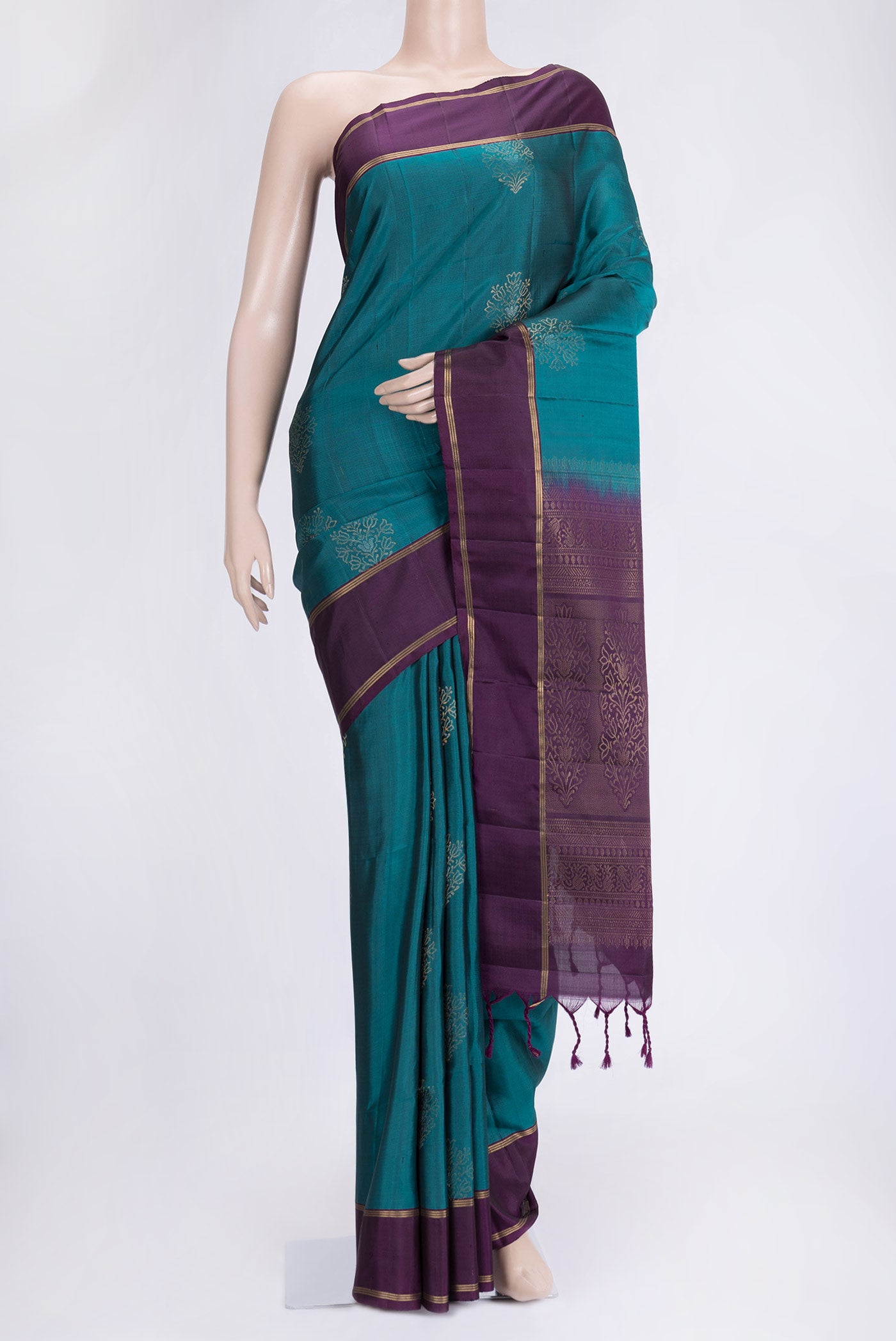 Peacock Blue Dual Tone Soft Silk Saree with Zari Butta on the body and Fancy Border.  displayed on a mannequin