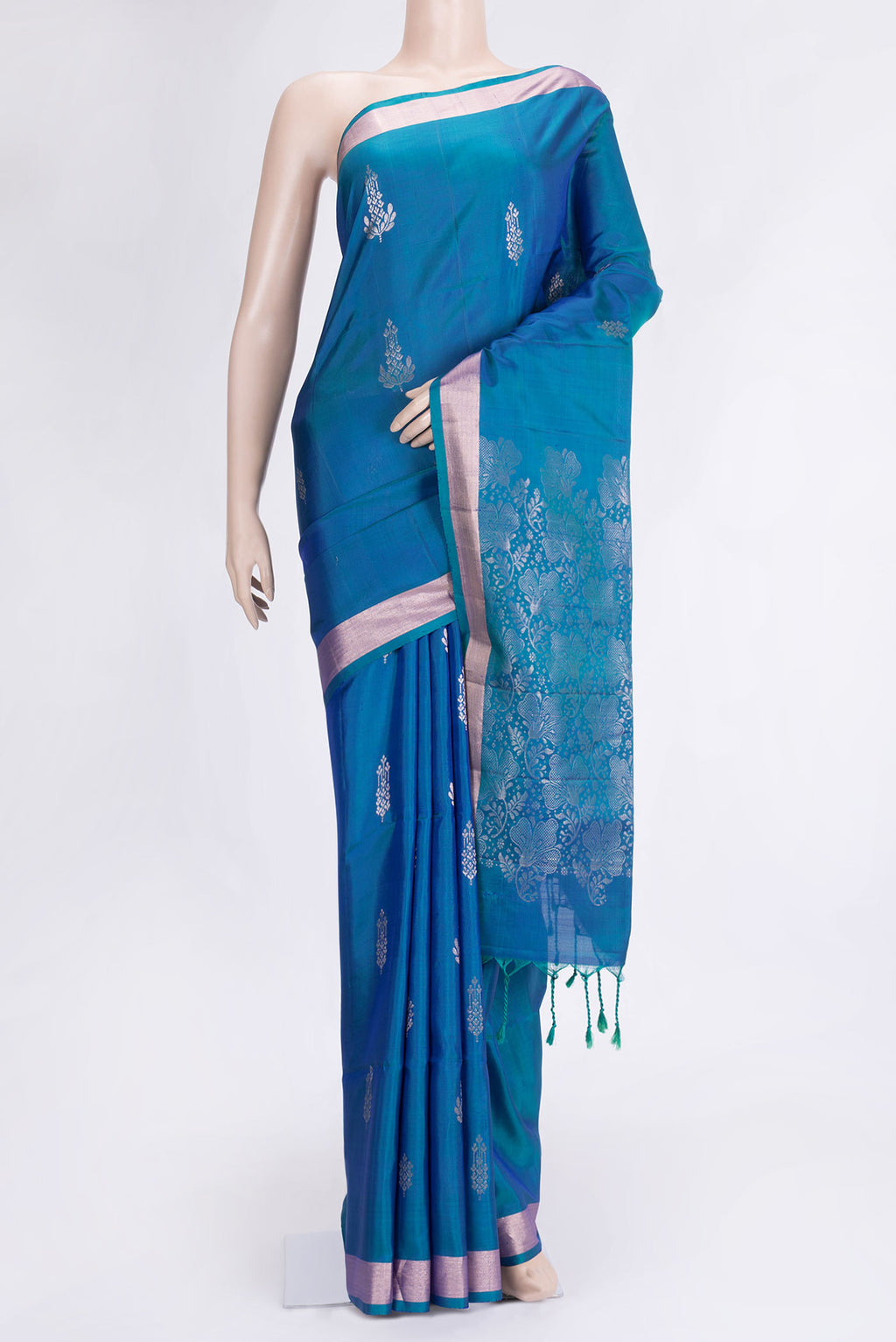 Peacock Blue Dual Tone Soft Silk Saree with Zari Butta on the body and Zari Border.  displayed on a mannequin