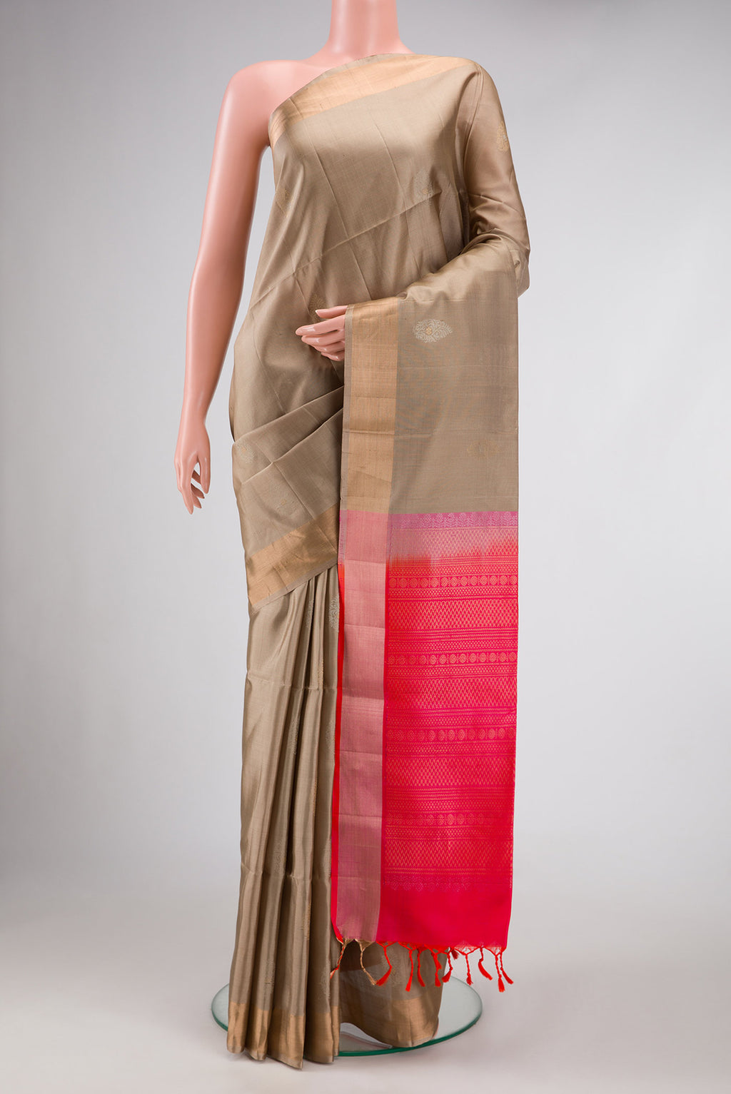 Beige Dual Tone Soft Silk Saree with Zari Butta on the body and Zari Border.  displayed on a mannequin