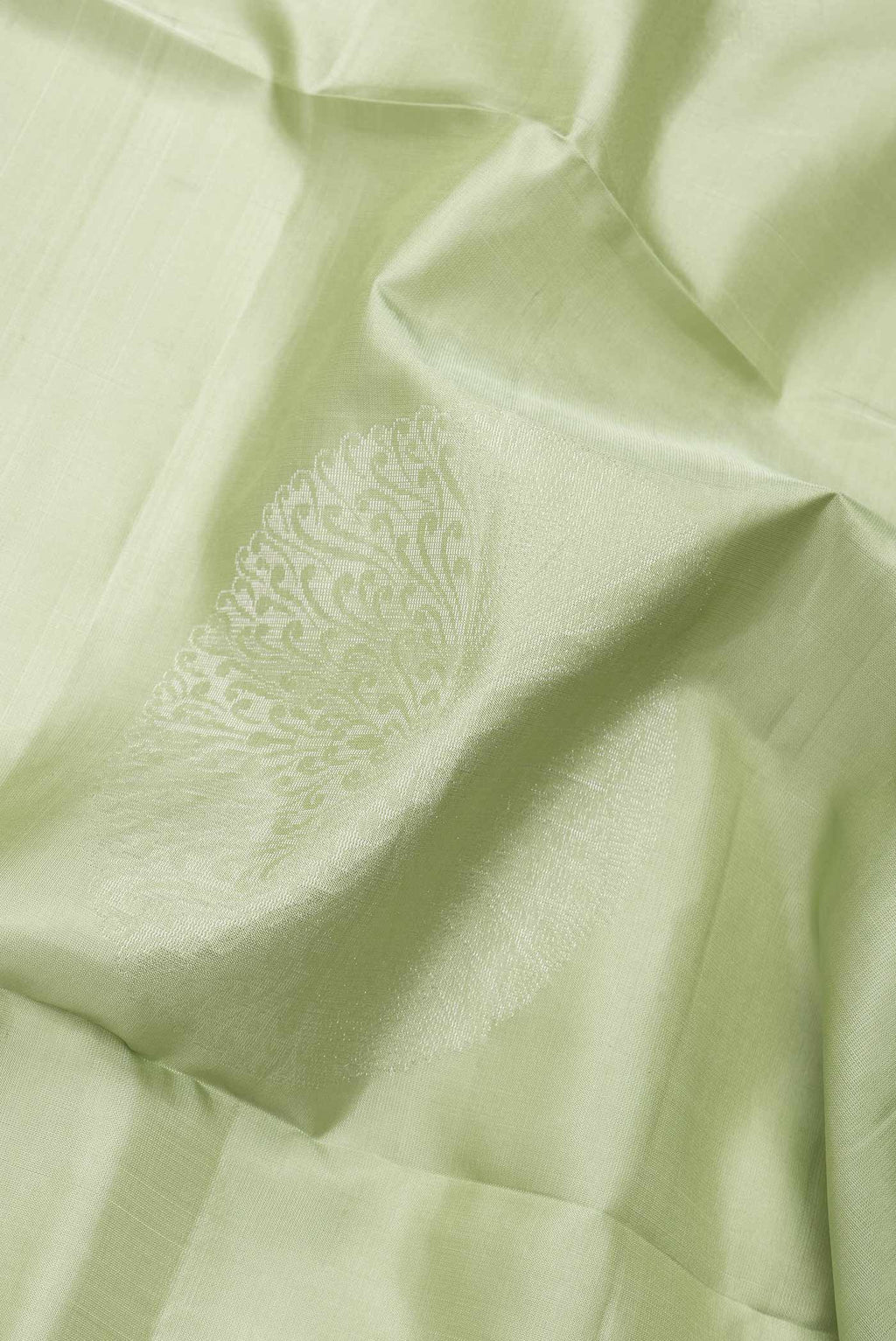 Close up of Pista Green Dual Tone Soft Silk Saree with Zari Butta on the body and Zari Border.  displaying folds