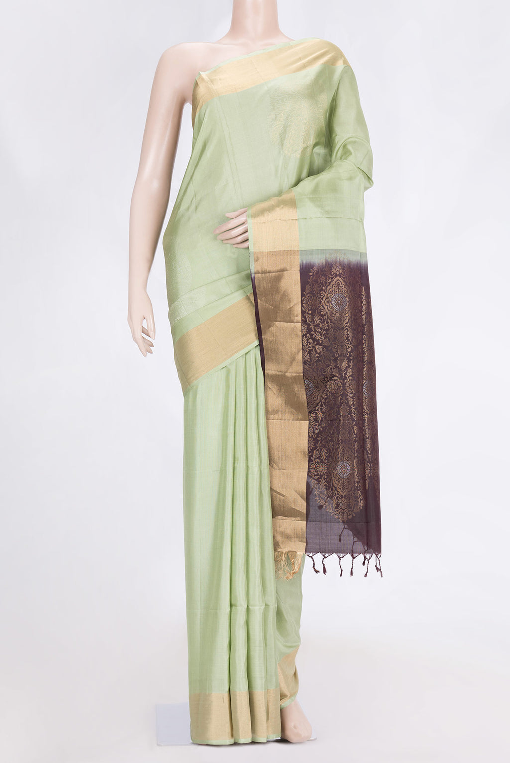 Pista Green Dual Tone Soft Silk Saree with Zari Butta on the body and Zari Border.  displayed on a mannequin