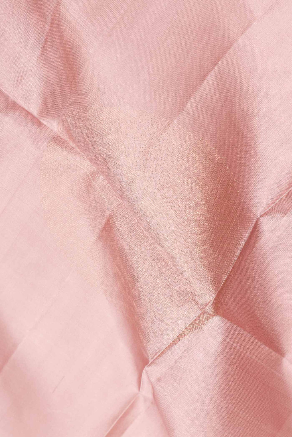 Close up of Rose Gold Dual Tone Soft Silk Saree with Zari Butta on the body and Zari Border.  displaying folds