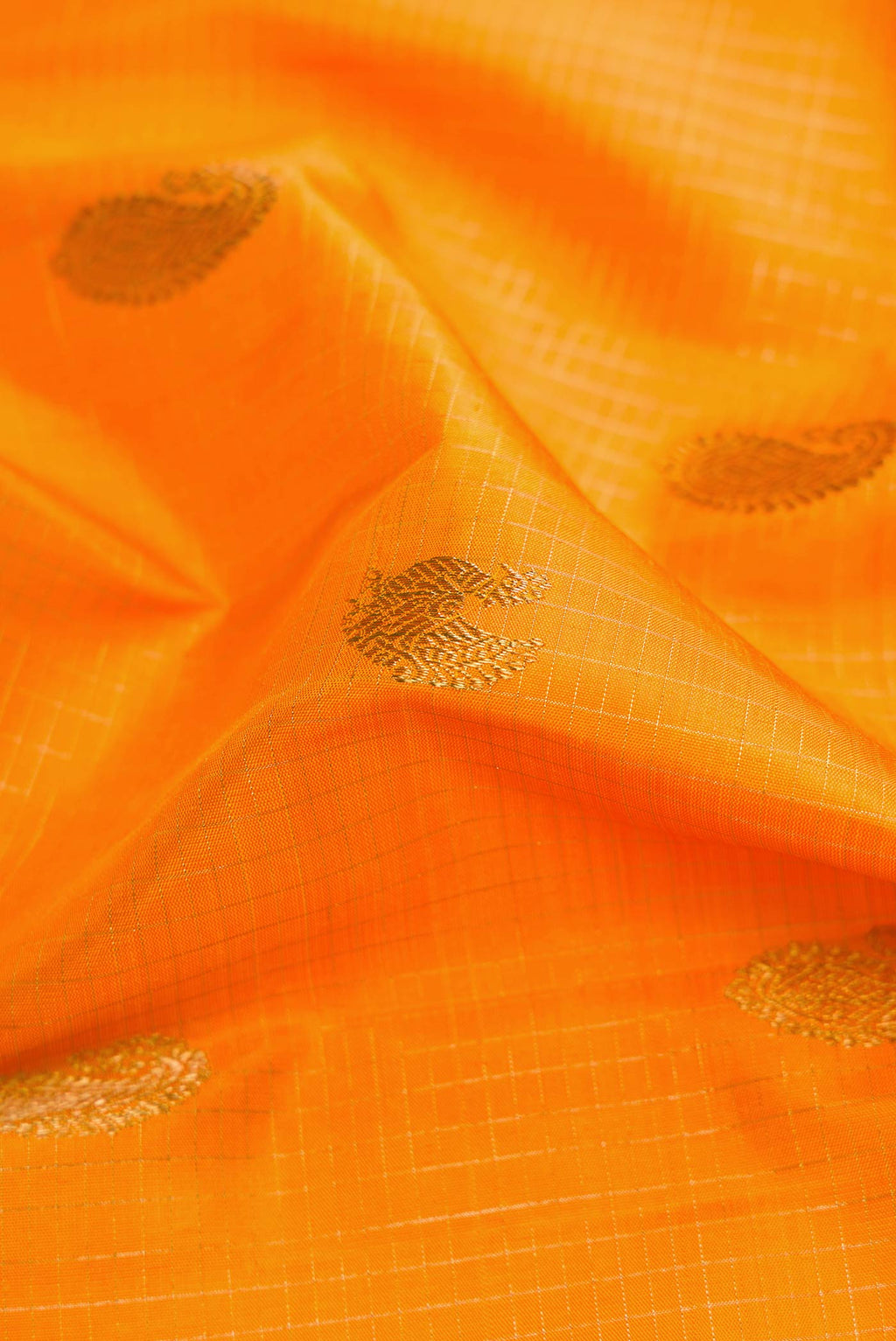 Close up of Pure Silk Pure Zari Yellow Kanchipuram Saree with Checked design on the body and Zari Border displaying folds