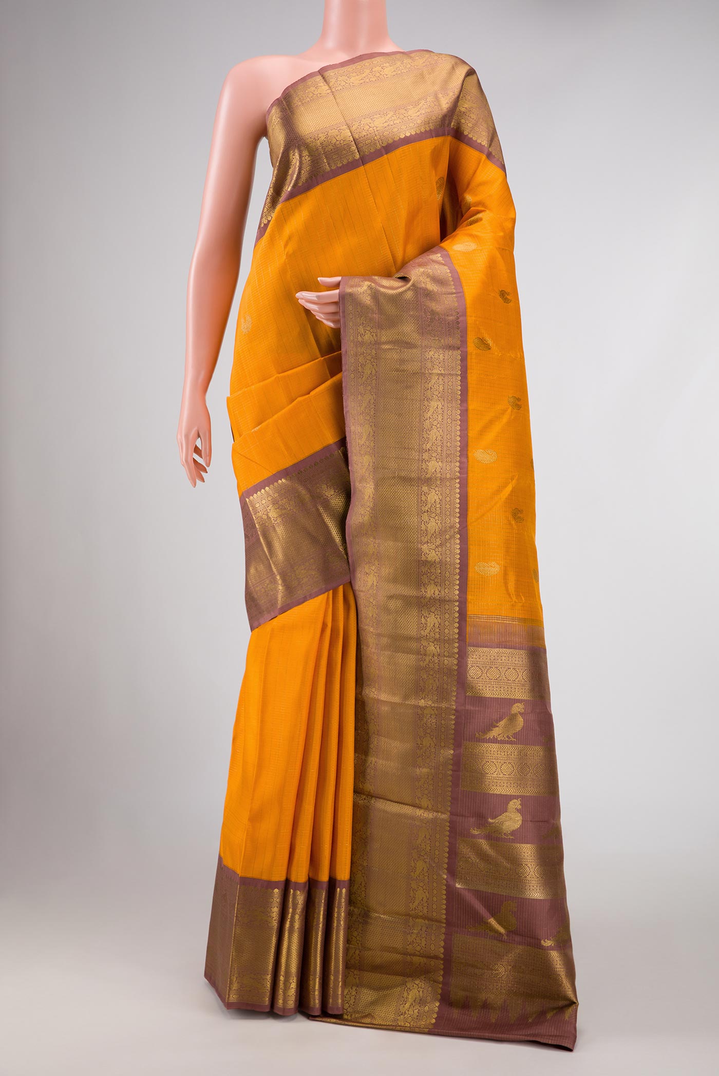 Pure Silk Pure Zari Yellow Kanchipuram Saree with Checked design on the body and Zari Border displayed on a mannequin