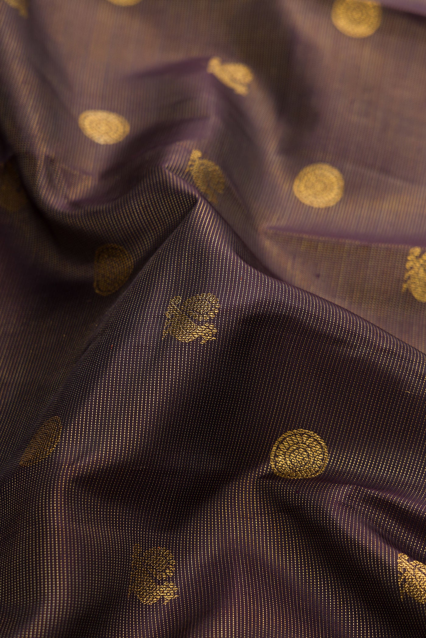 Close up of Pure Silk Pure Zari Brown Dual Tone Kanchipuram Saree with Zari Butta on the body and Zari Border.  displaying folds