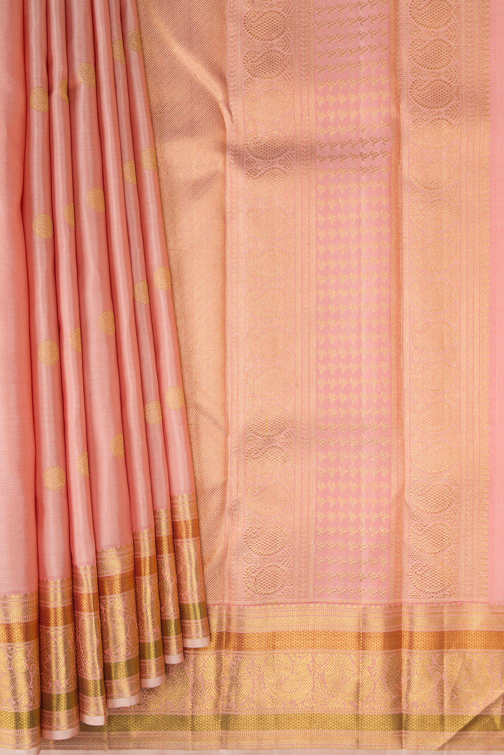 Pleats and pallu of Peach Kanchipuram Silk Saree with Zari Butta on the body and Zari And Thread Border. 
