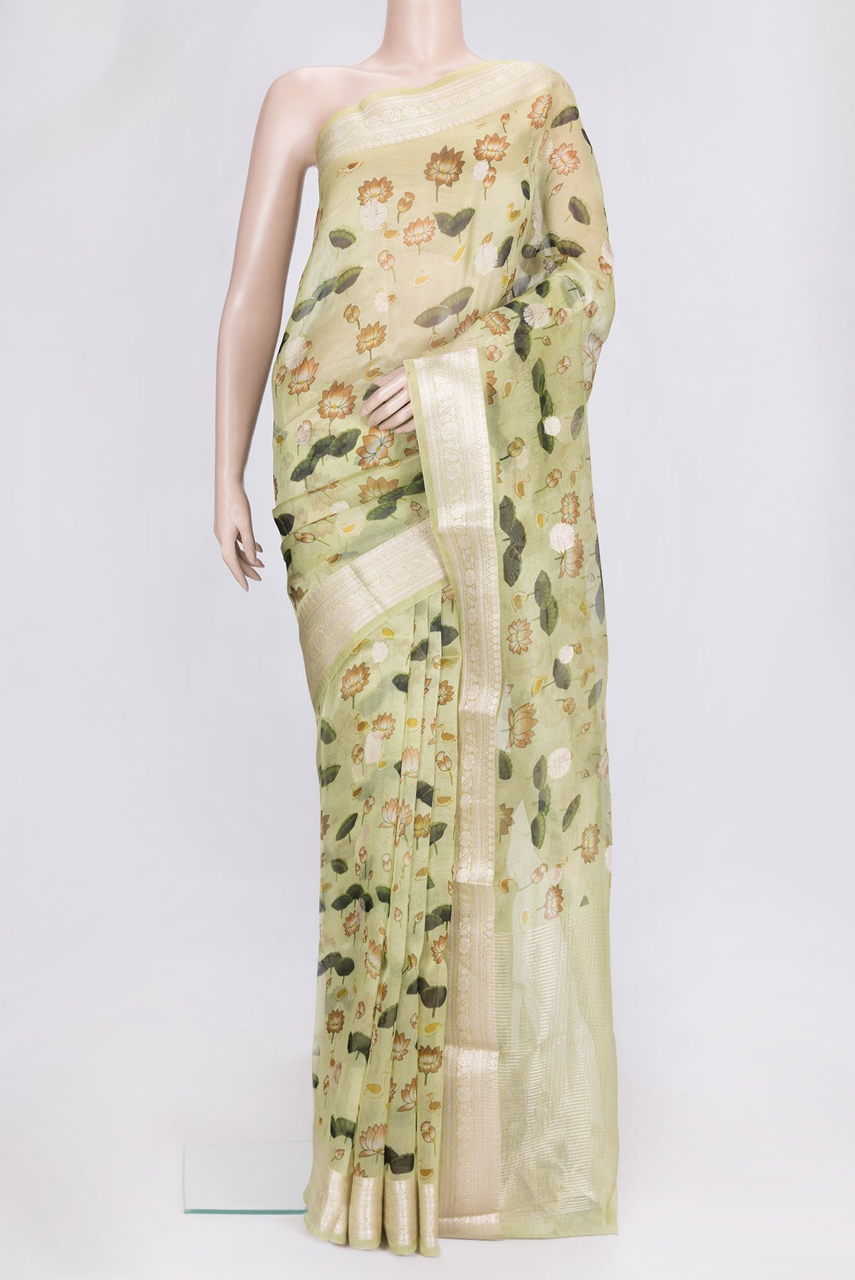 Pista Green Dual Tone Organza Silk Saree with Printed design on the body and Zari Border.  displayed on a mannequin