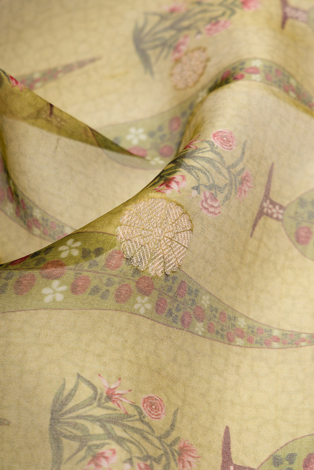 Close up of Pista Green Dual Tone Organza Silk Saree with Printed design on the body and Zari Border.  displaying folds