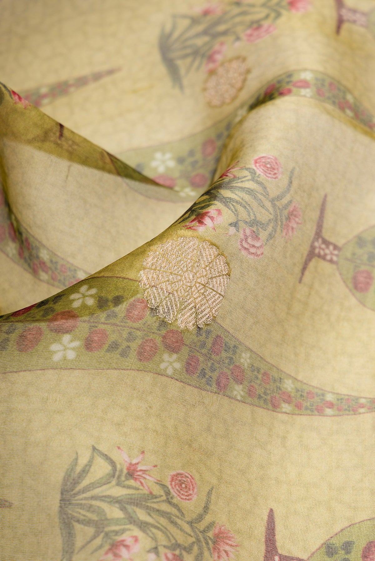 Close up of Pista Green Dual Tone Organza Silk Saree with Printed design on the body and Zari Border.  displaying folds