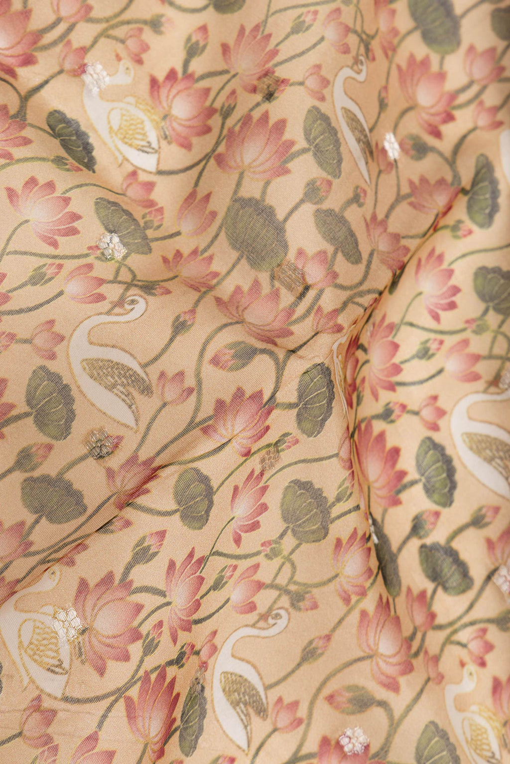 Close up of Peach Dual Tone Organza Silk Saree with Printed design on the body and Zari Border.  displaying folds