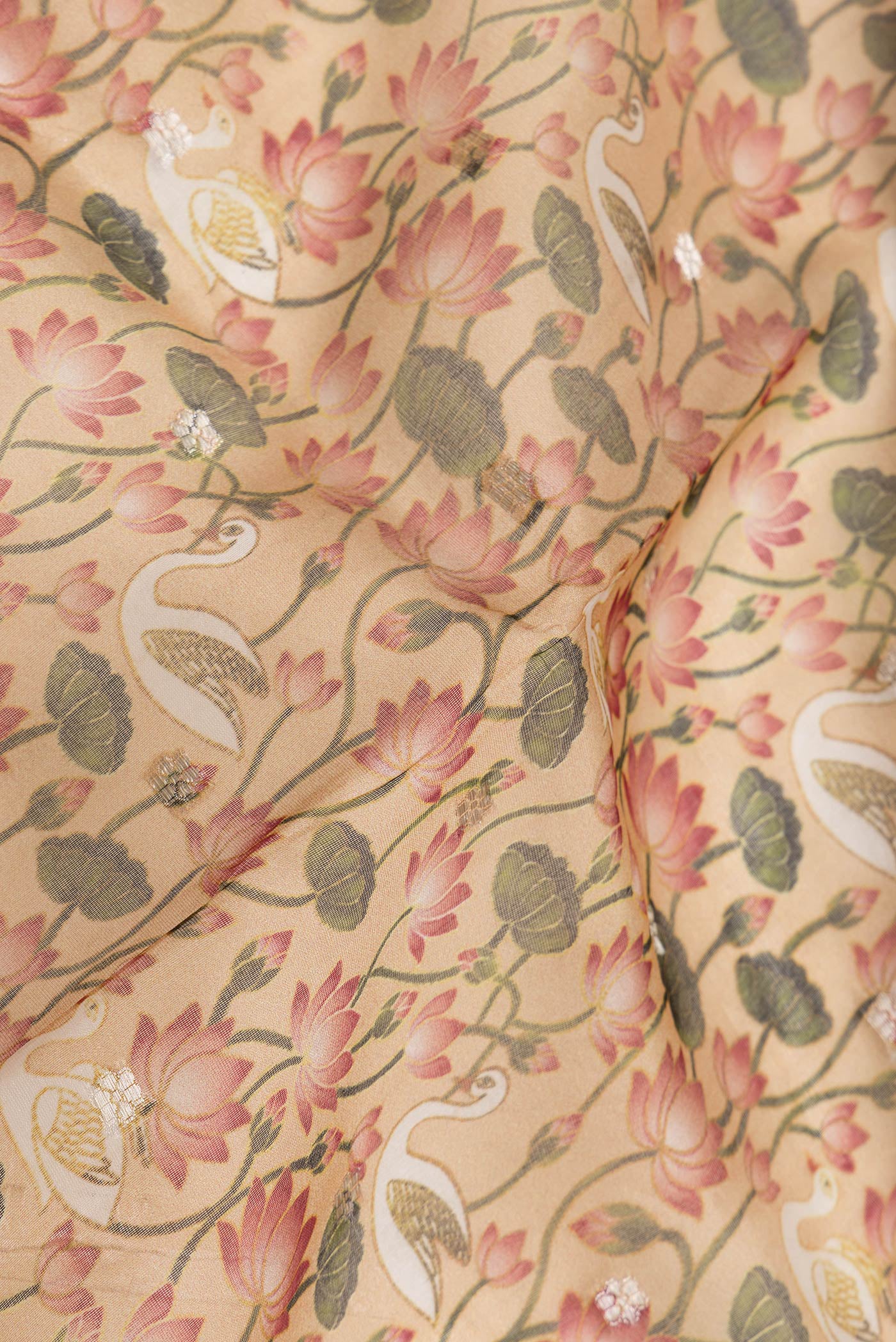 Close up of Peach Dual Tone Organza Silk Saree with Printed design on the body and Zari Border.  displaying folds