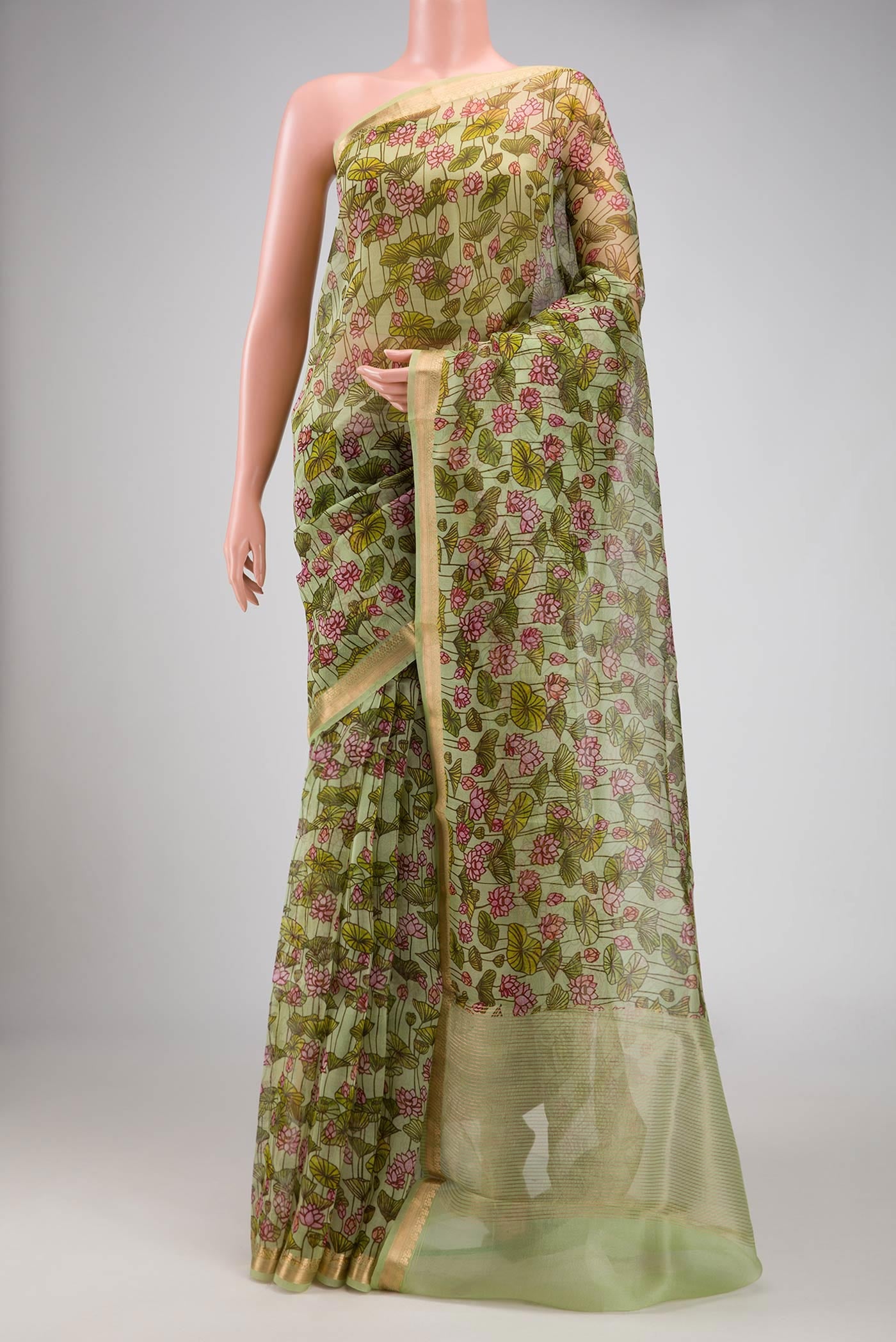 Pista Green Dual Tone Organza Silk Saree with Printed design on the body and Zari Border.  displayed on a mannequin