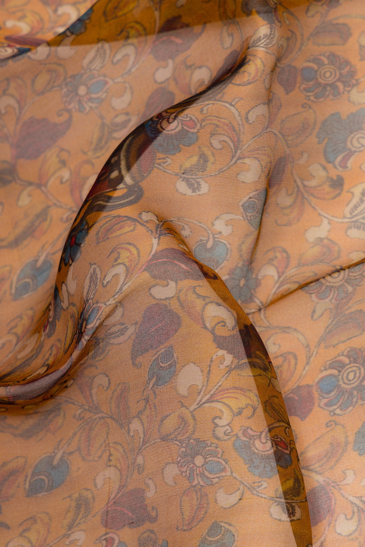 Close up of Mustard Dual Tone Organza Silk Saree with Printed design on the body and Zari Border.  displaying folds