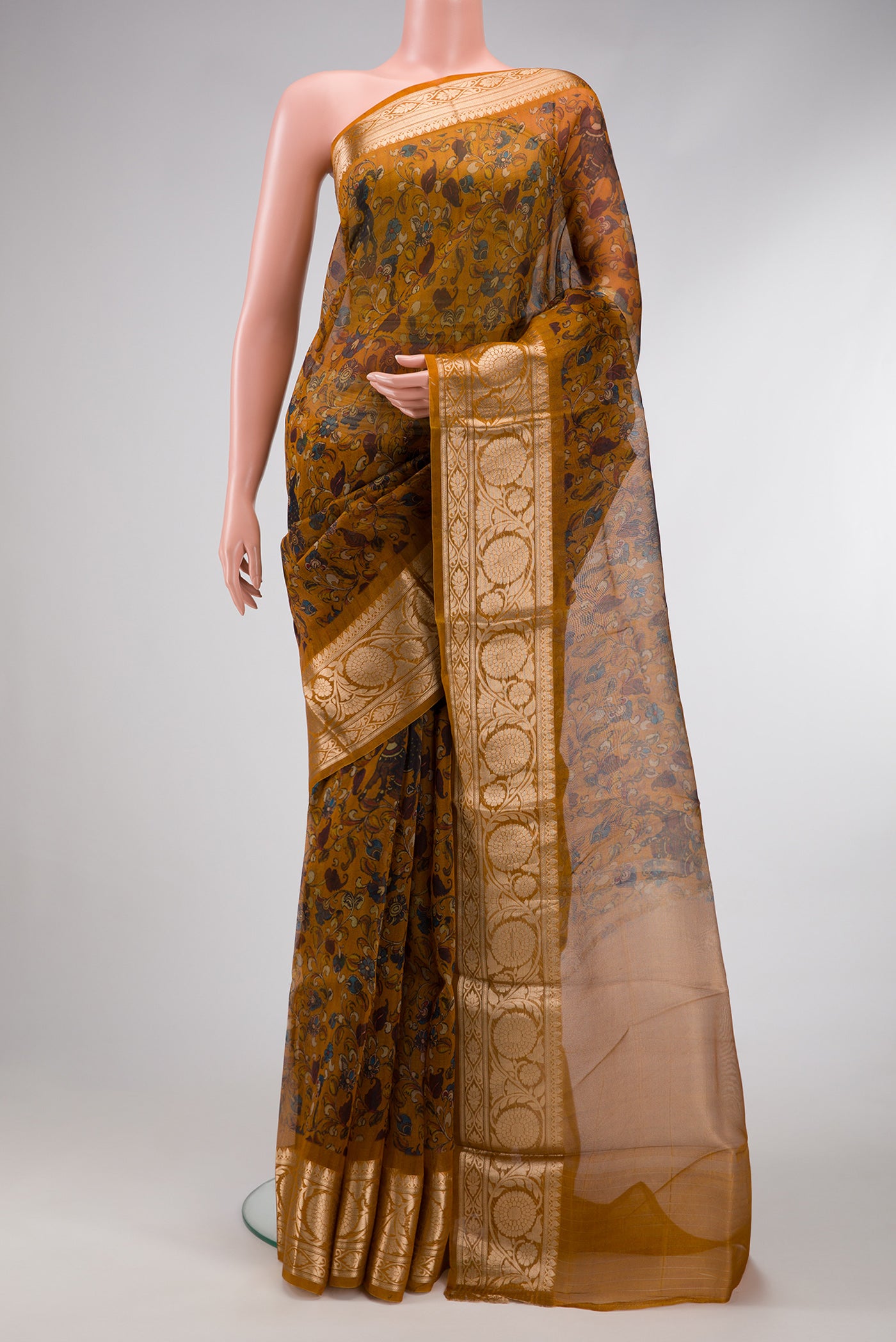 Mustard Dual Tone Organza Silk Saree with Printed design on the body and Zari Border.  displayed on a mannequin