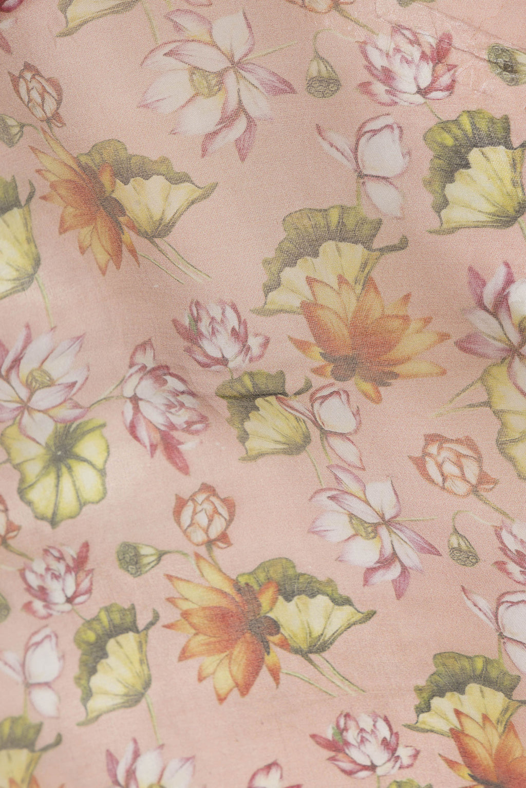 Close up of Orange Dual Tone Organza Silk Saree with Printed design on the body and Zari Border.  displaying folds
