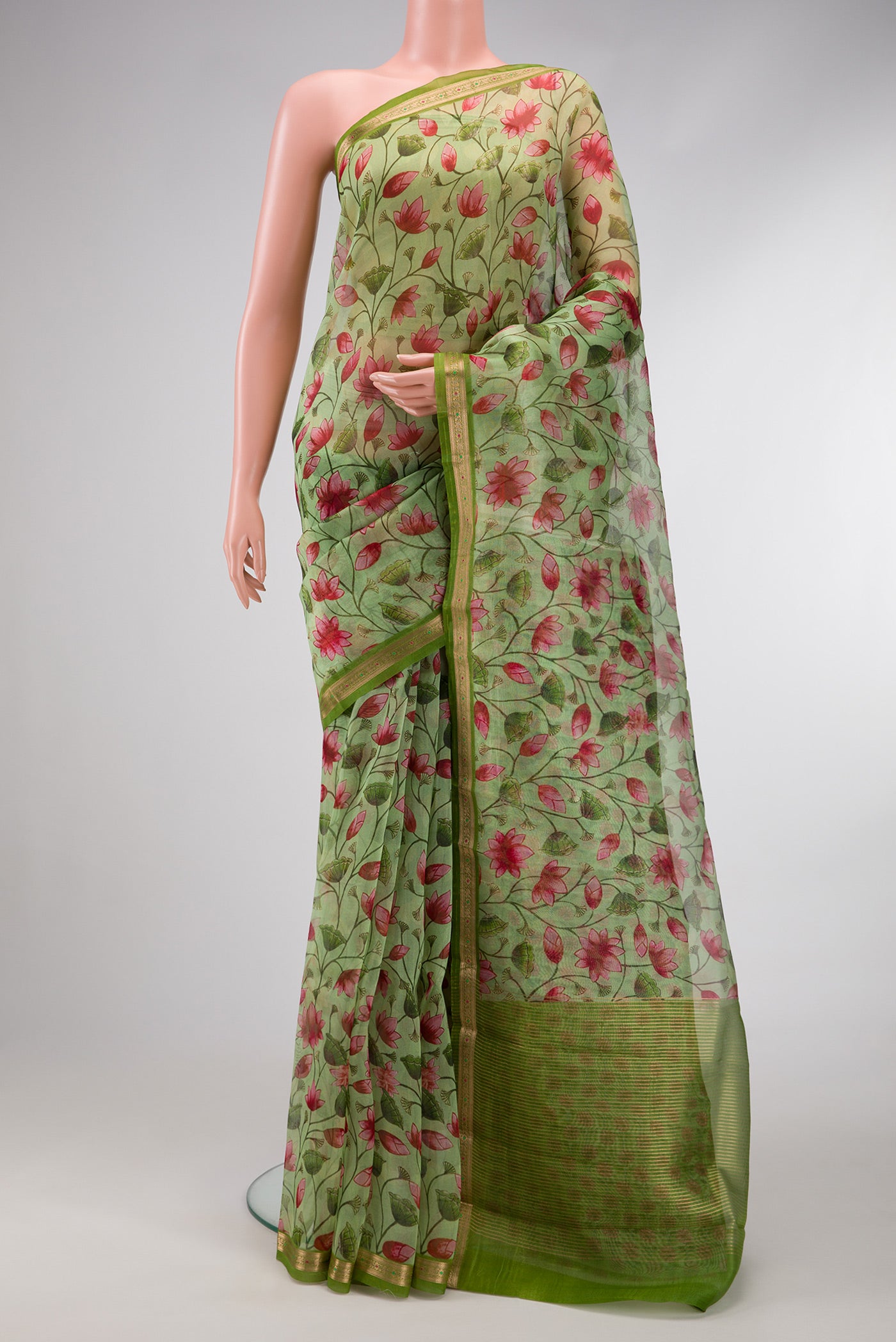 Green Dual Tone Organza Silk Saree with Printed design on the body and Zari Border.  displayed on a mannequin