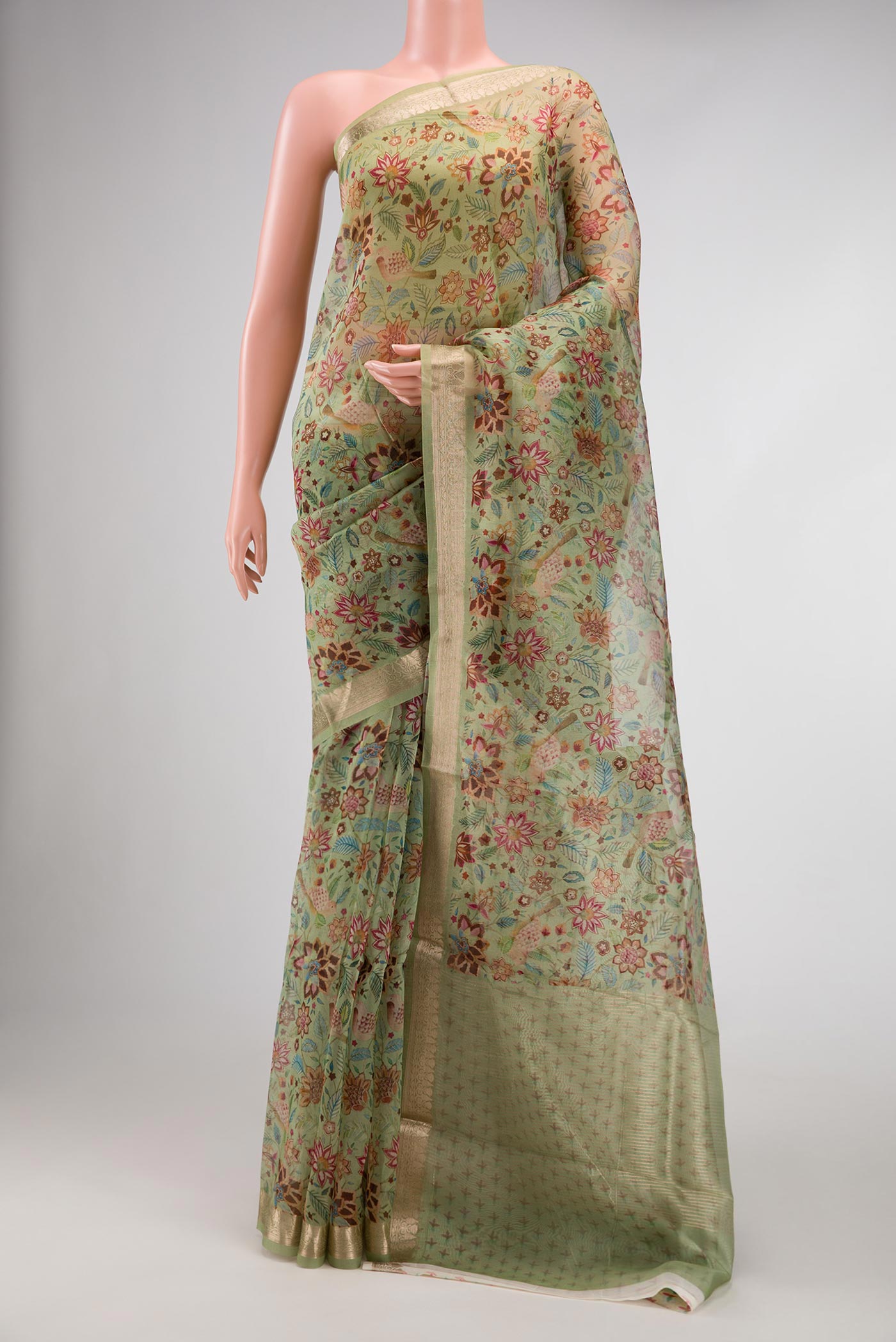 Pista Green Dual Tone Organza Silk Saree with Printed design on the body and Zari Border.  displayed on a mannequin