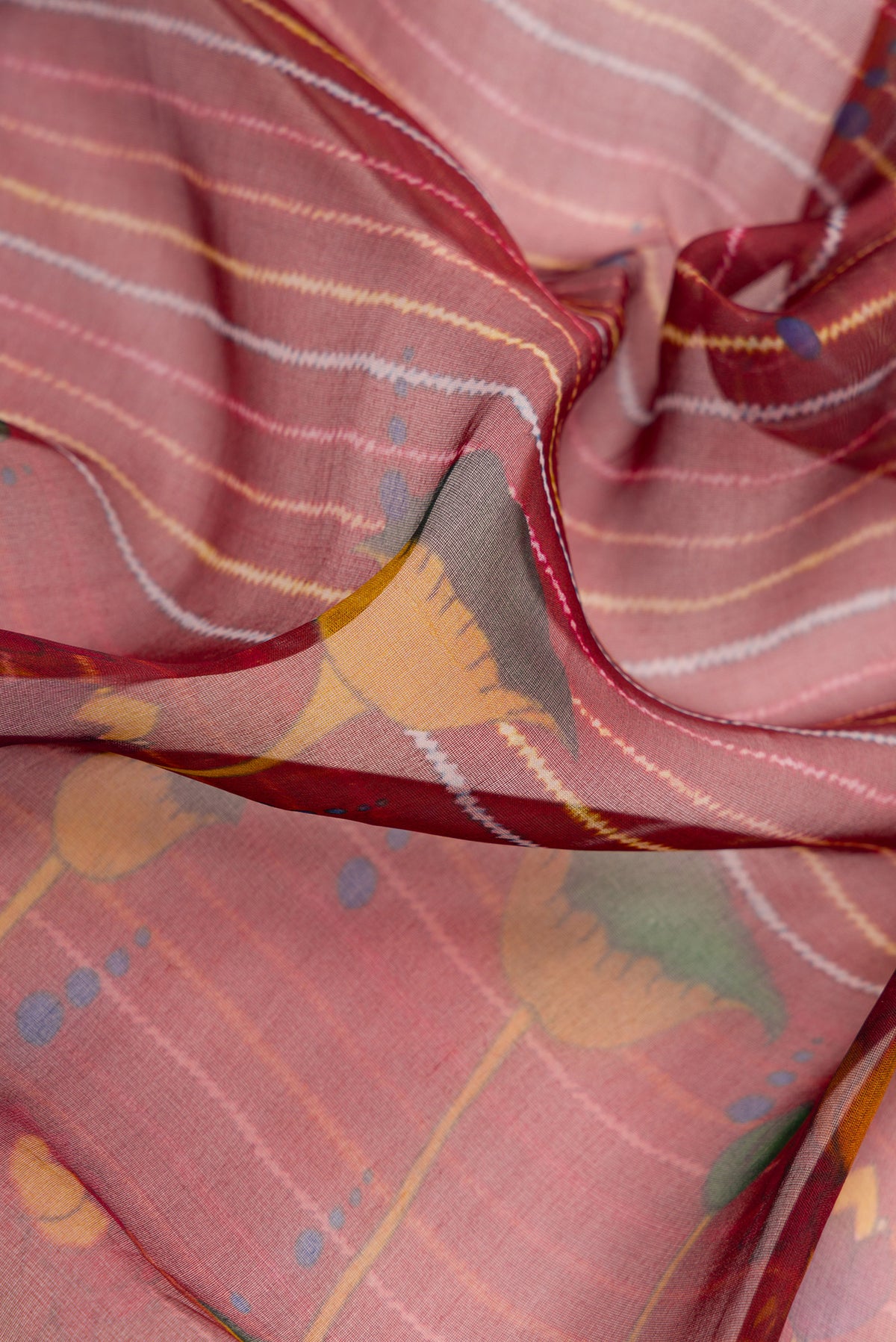 Close up of Maroon Dual Tone Organza Silk Saree with Printed design on the body and Zari Border.  displaying folds