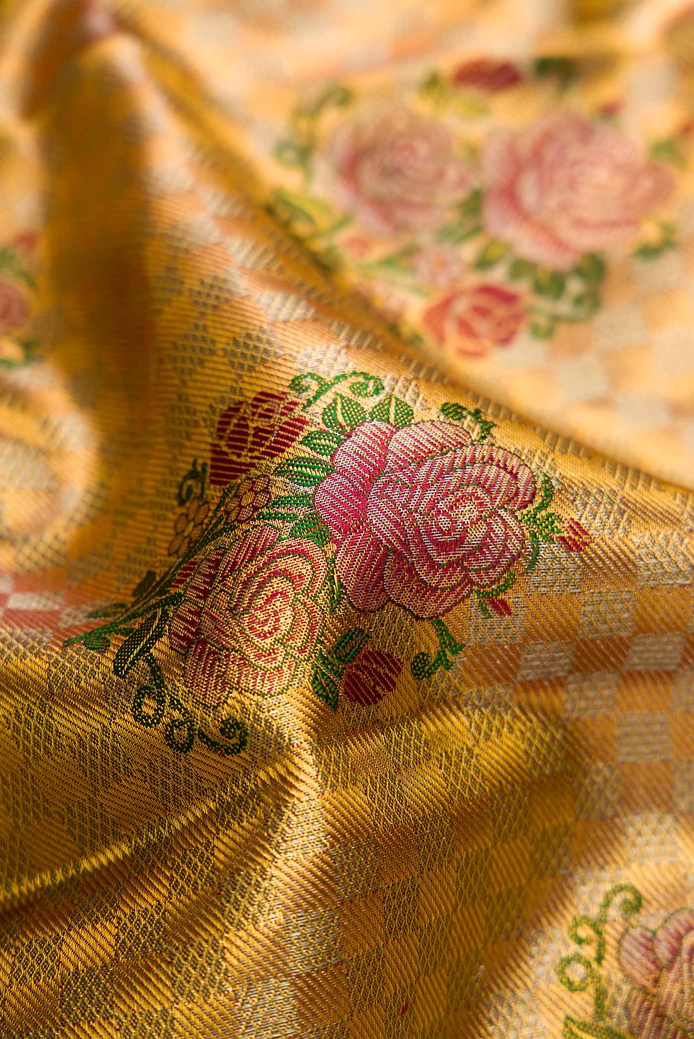 Close up of Gold Dual Tone Kanjivaram Tissue Silk Saree with Zari Brocade on the body and Zari Border.  displaying folds