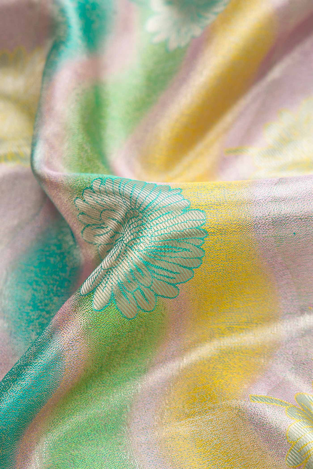 Close up of Green and Lavender Color Kanjivaram Tissue Silk Saree with Zari Brocade on the body and Zari Border.  displaying folds