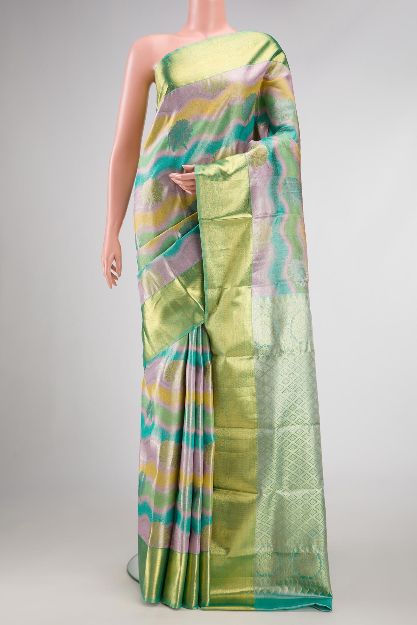 Green and Lavender Color Kanjivaram Tissue Silk Saree with Zari Brocade on the body and Zari Border.  displayed on a mannequin