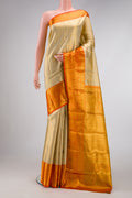 Gold Dual Tone Kanjivaram Tissue Silk Saree with Zari Brocade on the body and Zari Border.  displayed on a mannequin