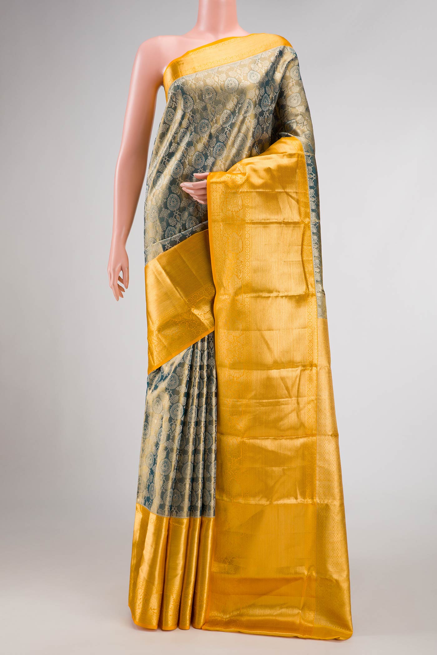Mehandi Green Dual Tone Kanjivaram Tissue Silk Saree with Zari Brocade on the body and Zari Border.  displayed on a mannequin